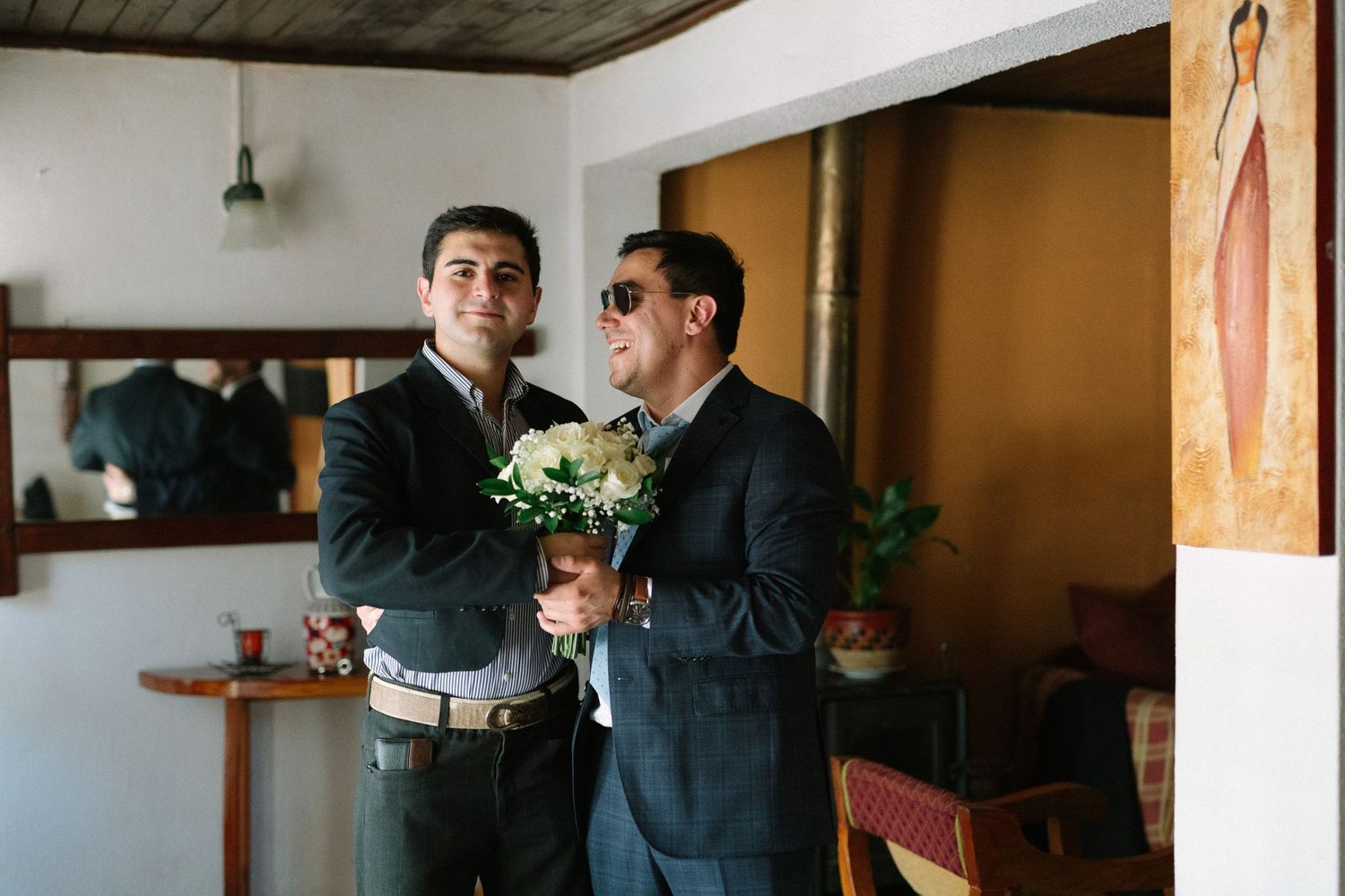 Two people sharing special moment with white floral bouquet.