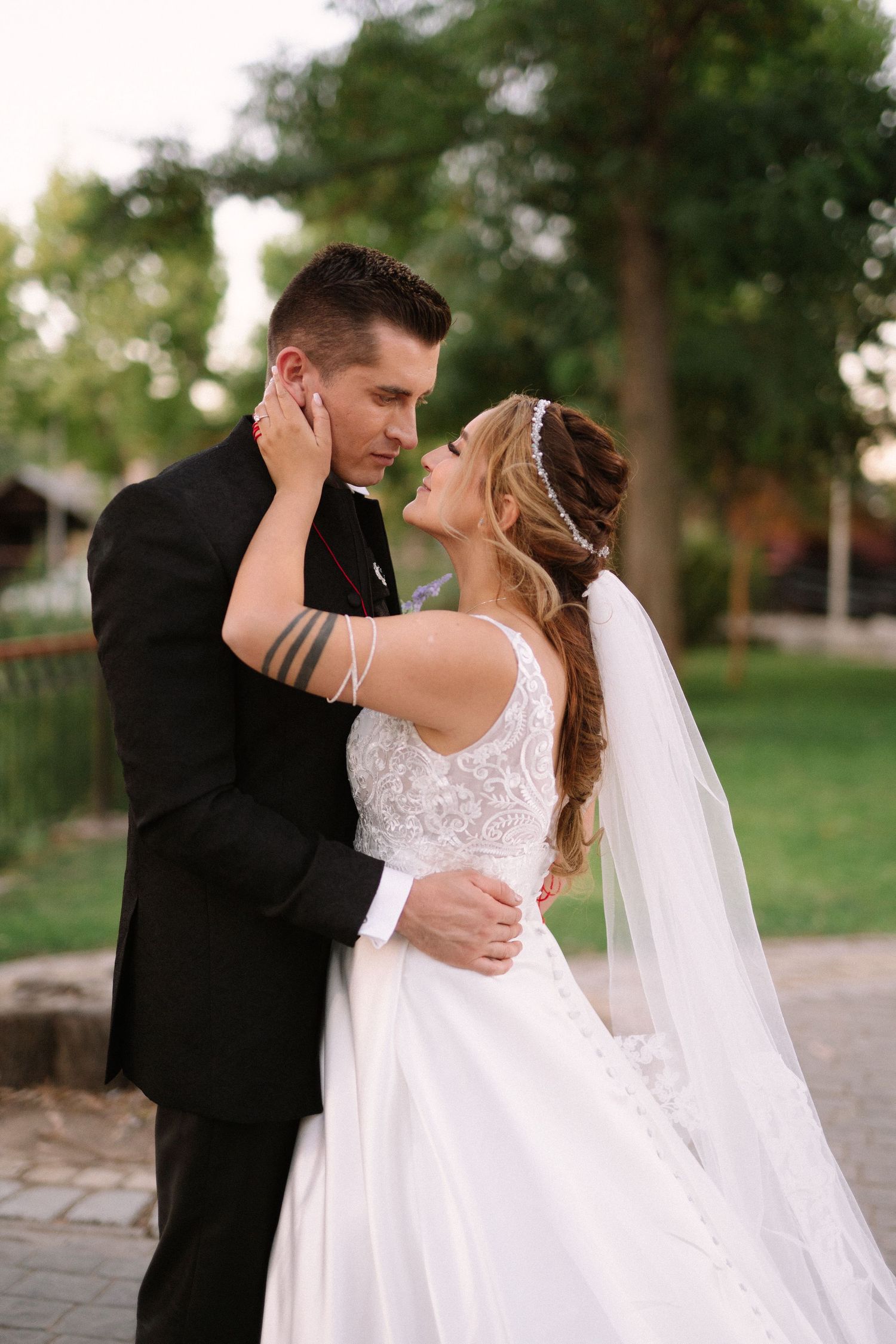 A tender moment captured between newlyweds in an outdoor garden setting.