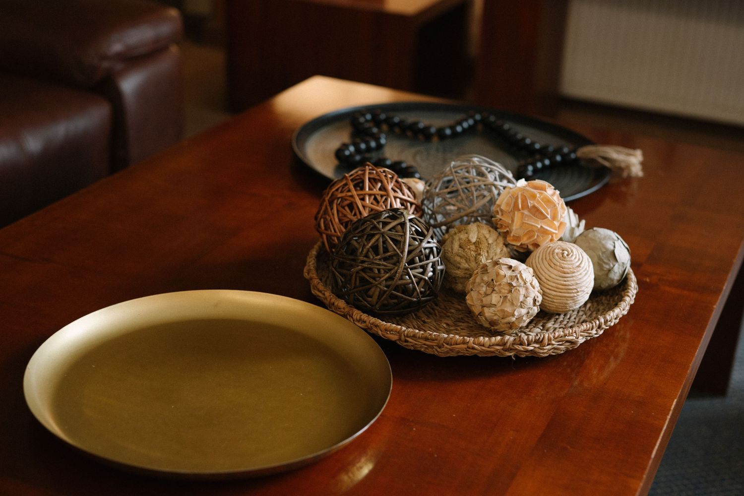 Bowl of assorted cookies and pastries on wooden table next to yellow soup bowl.