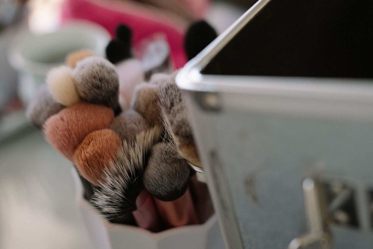 Close-up shot of cat paws reaching toward an electronic device.