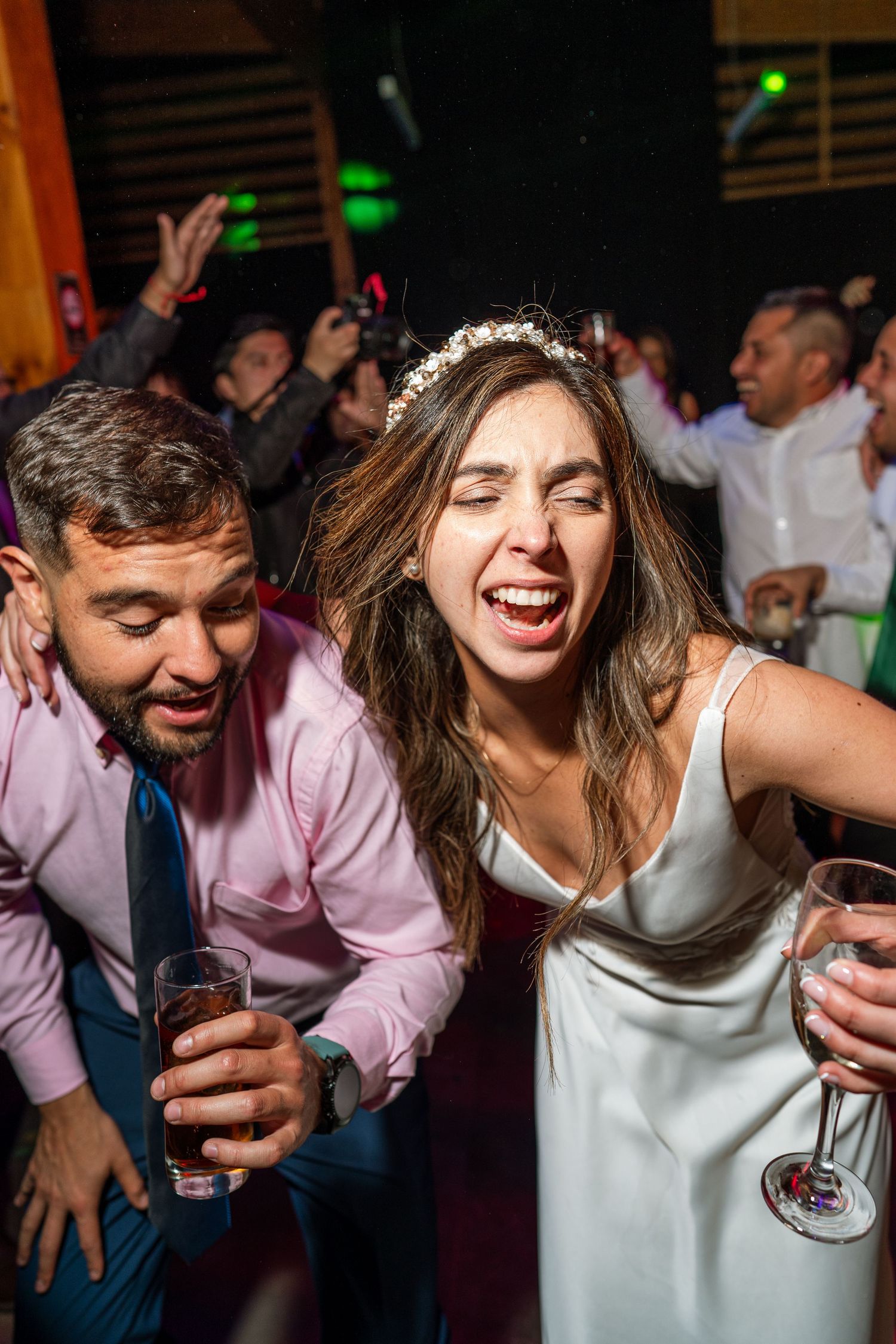 Energetic dancing and celebrating at a wedding reception party.