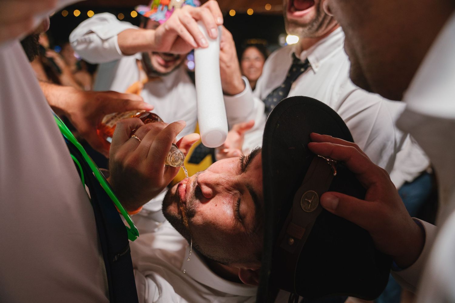 Wedding reception guests participate in lively party games and celebrations.