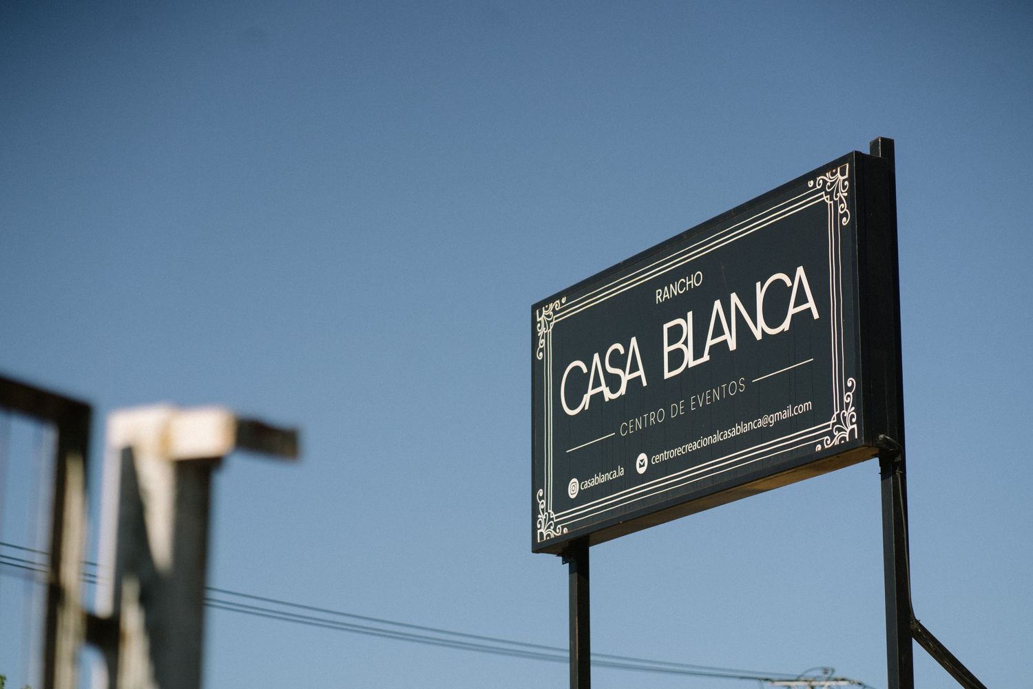 Black and white Casa Blanca business sign against blue sky.