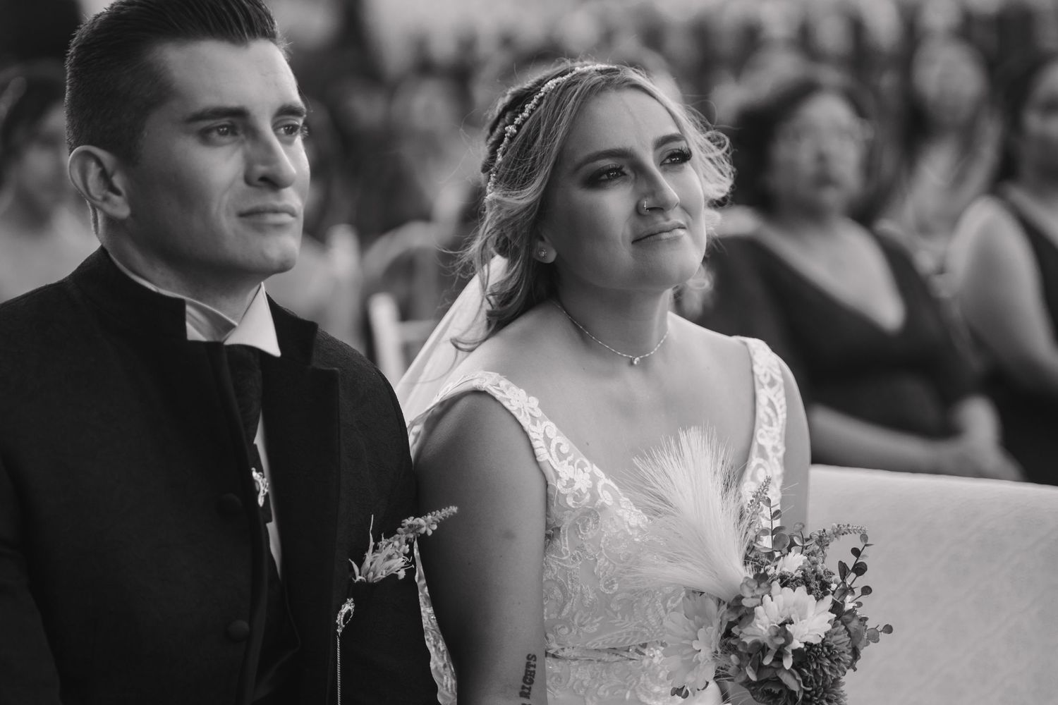 Black and white portrait of couple during outdoor wedding ceremony.
