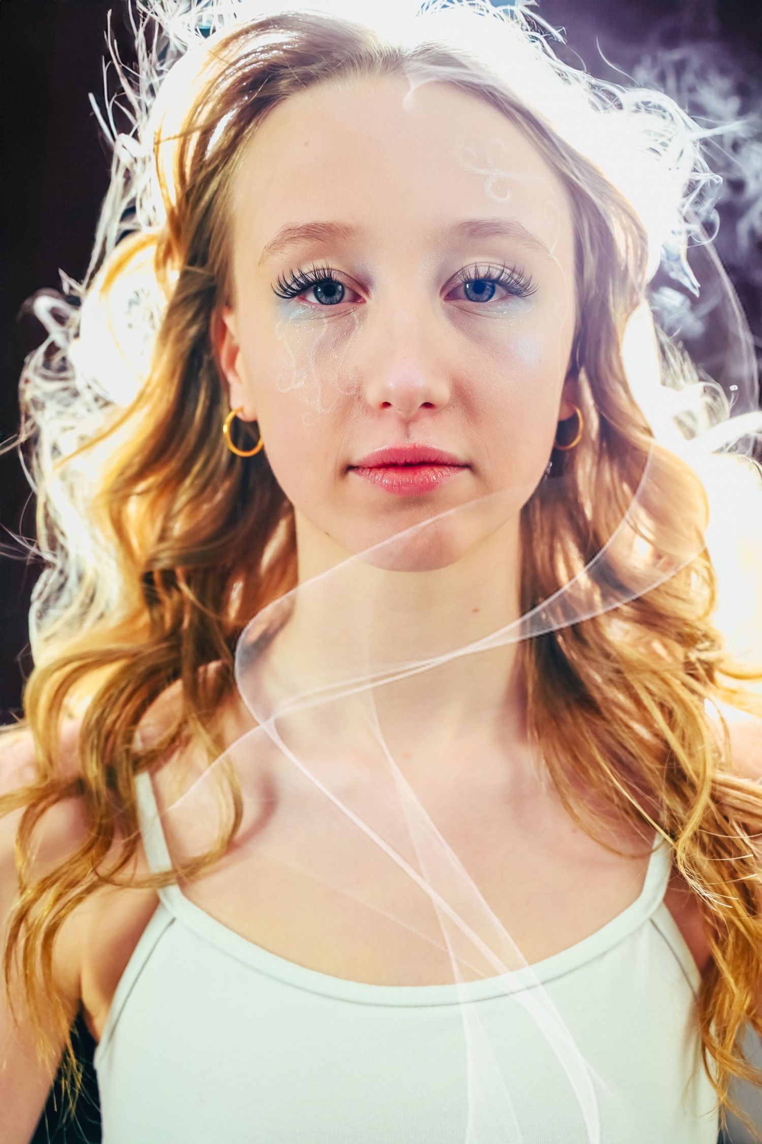 Portrait with ethereal backlit effect and soft lighting creating dreamy atmosphere.
