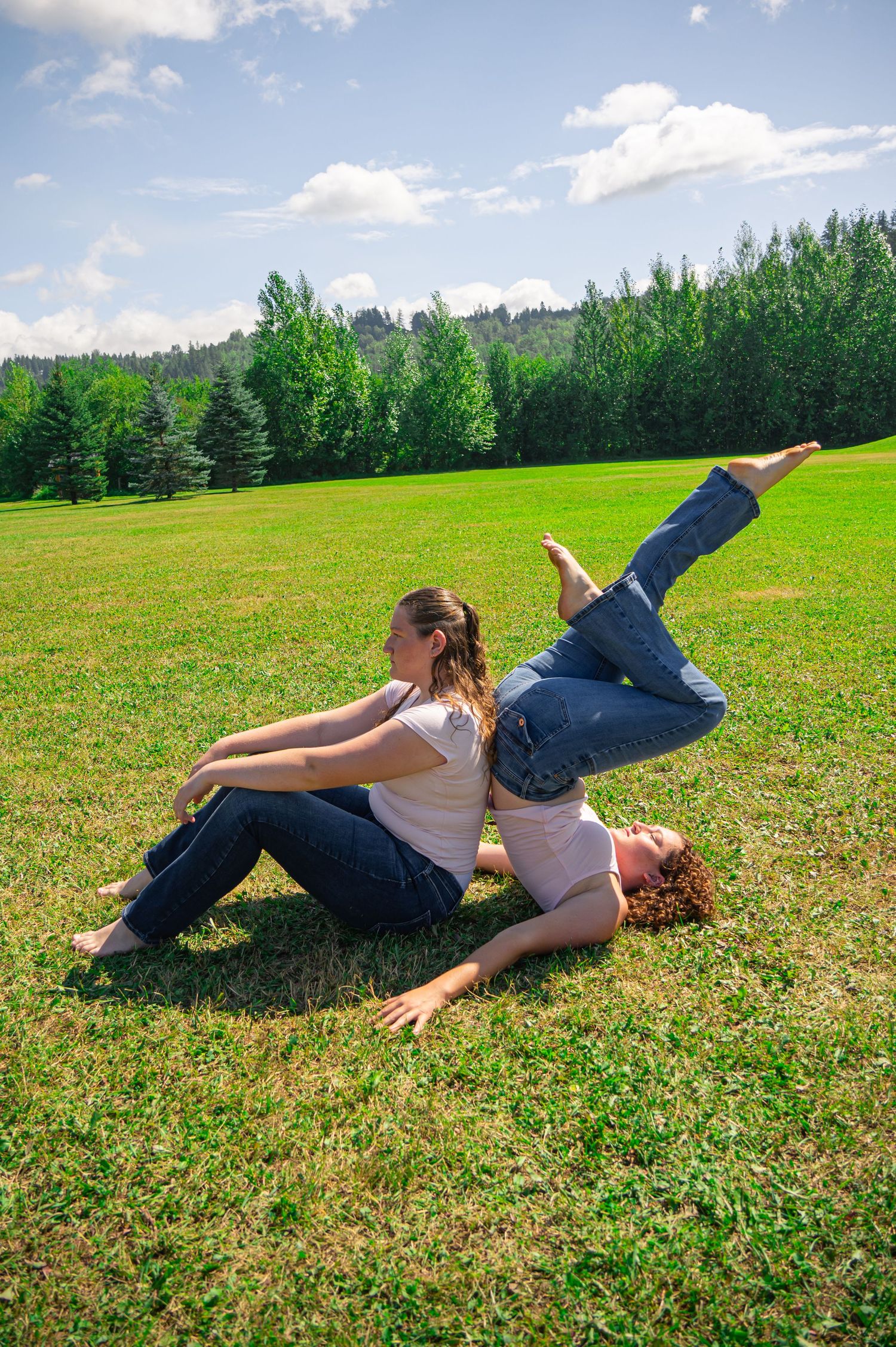 Progressive sequence showing someone rolling across a sunny green field with trees in the background.