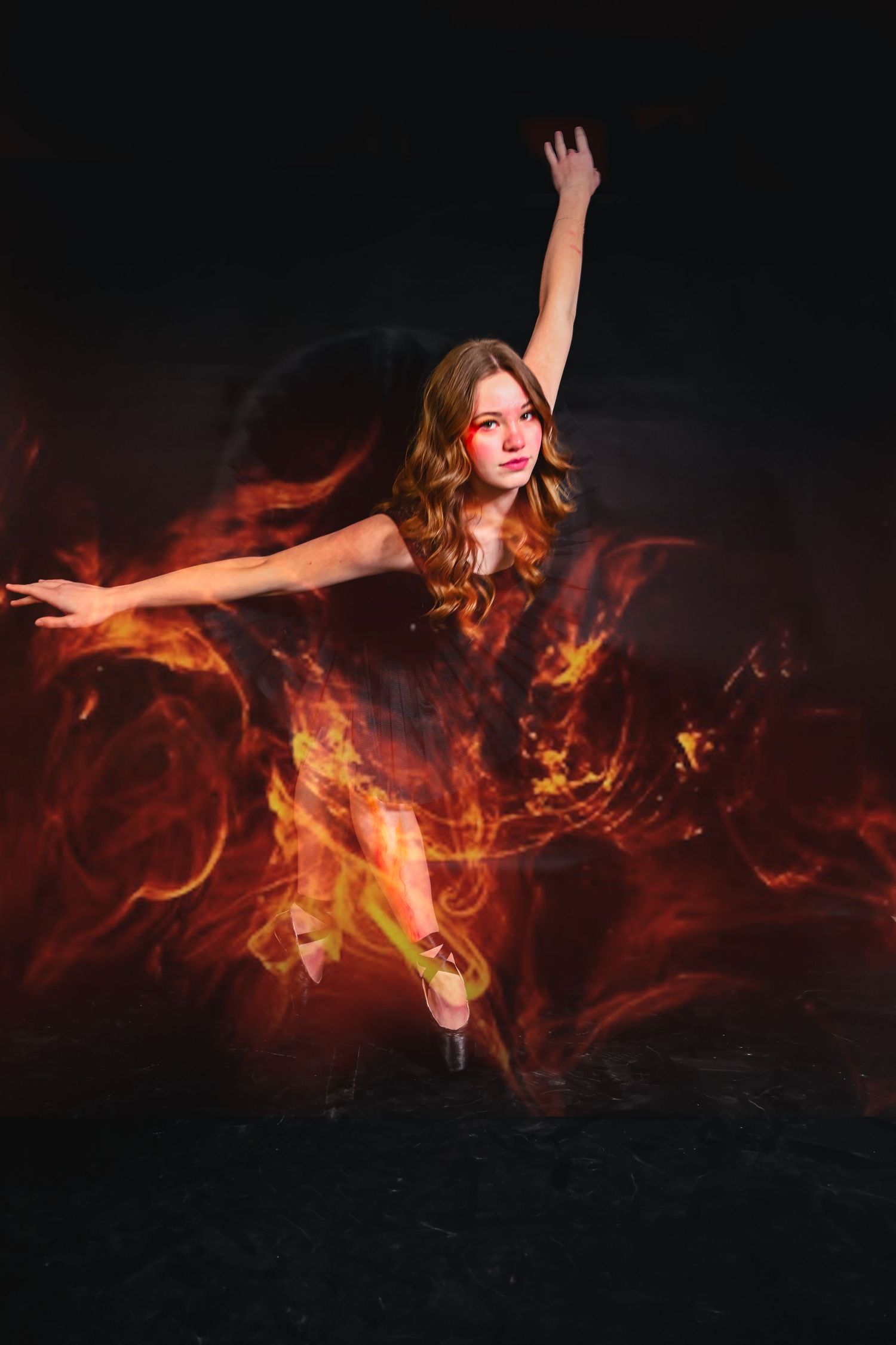 Dramatic dance pose surrounded by digital fire effects on dark background.