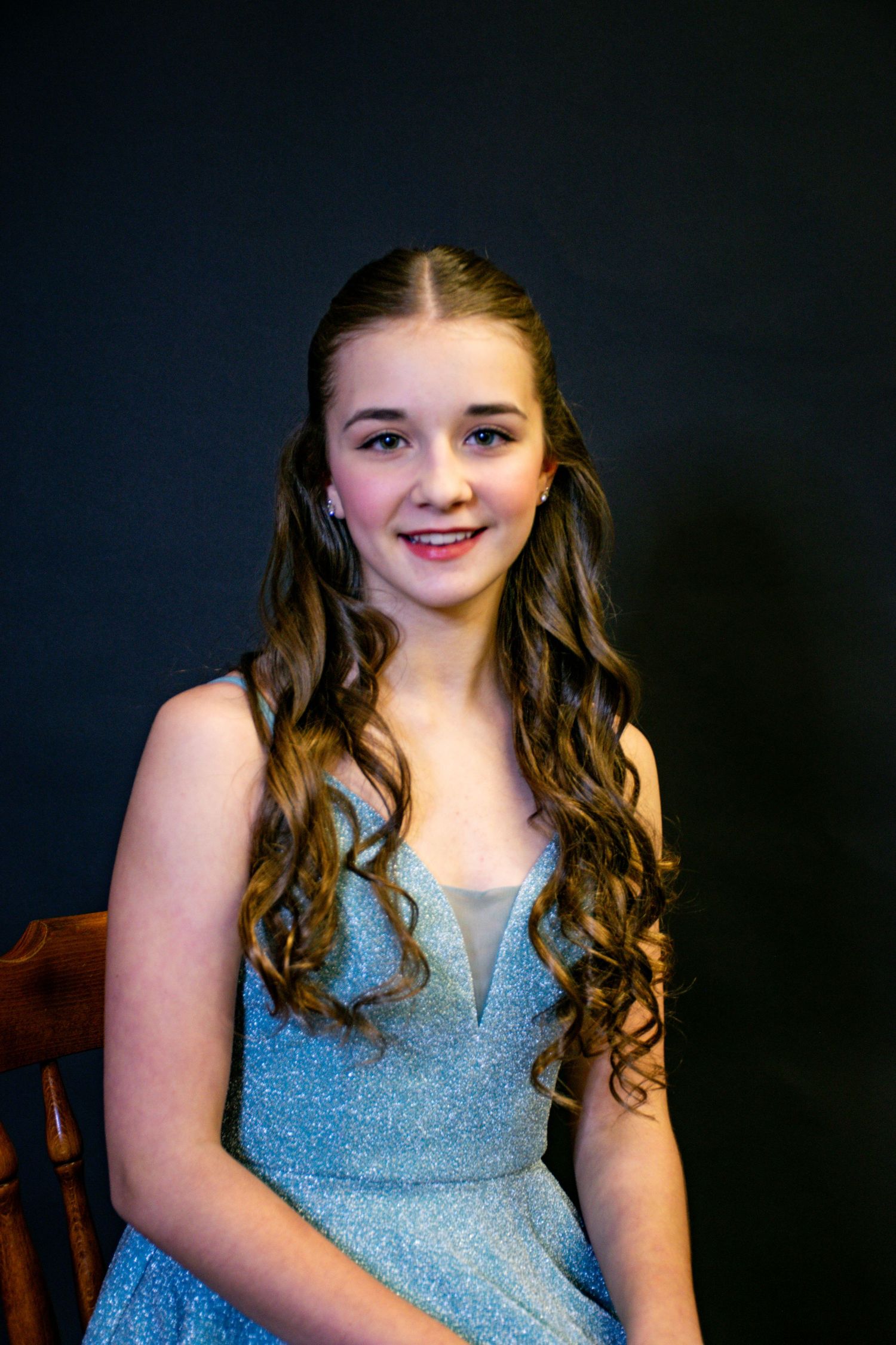 A young girl sitting posed
