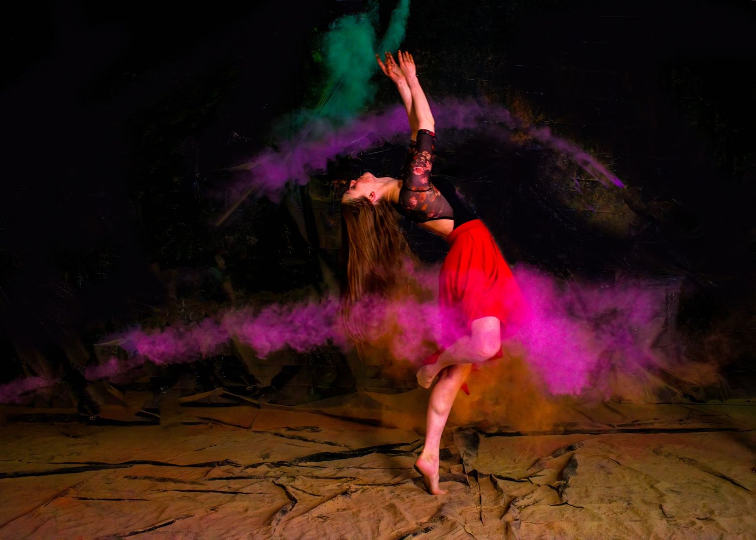 Contemporary dance move with red and purple smoke effects creating dramatic atmosphere.