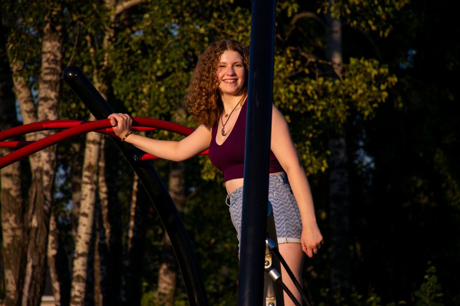 A person posed on a playground.