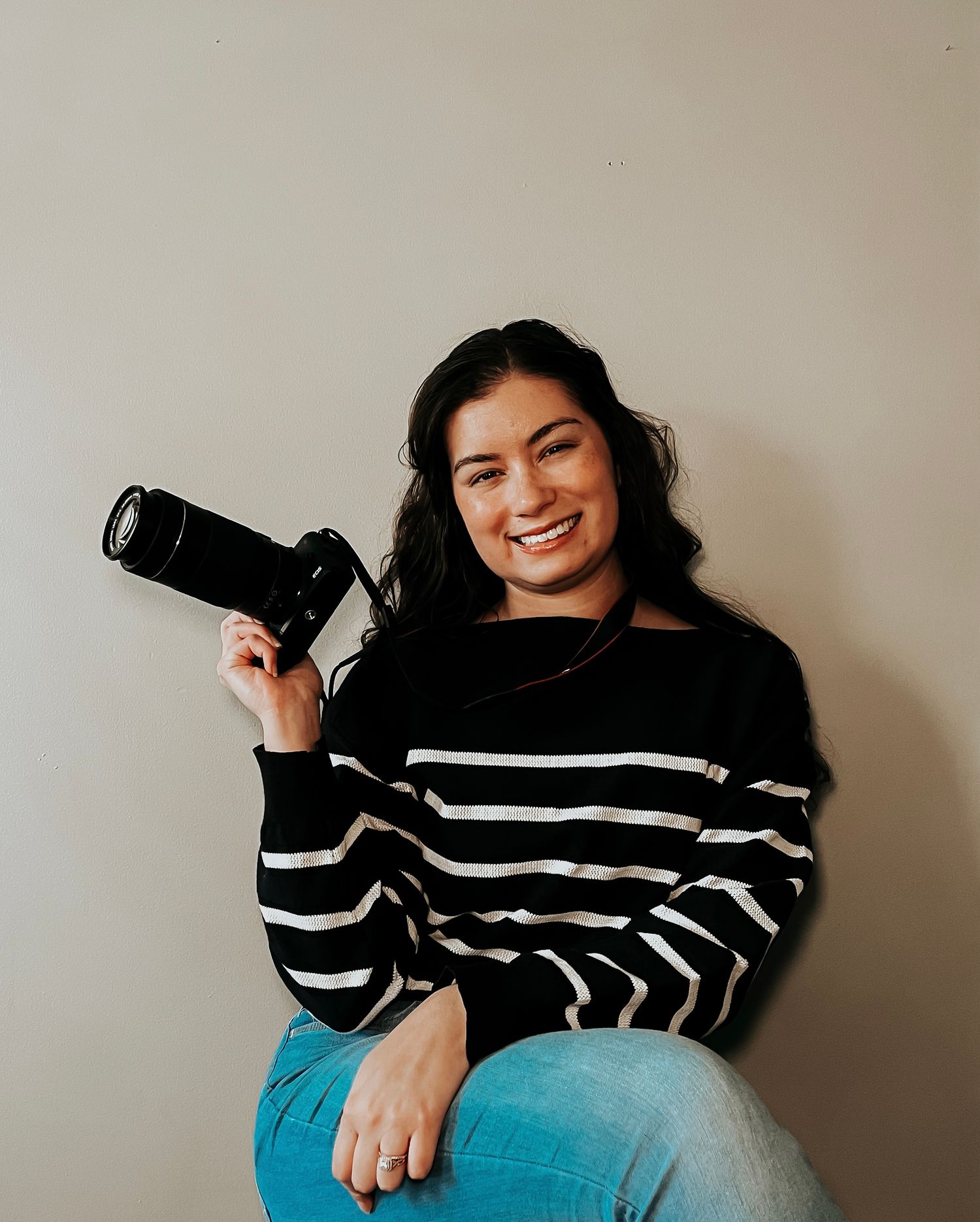 sun prairie photographer, sitting and holding a camera
