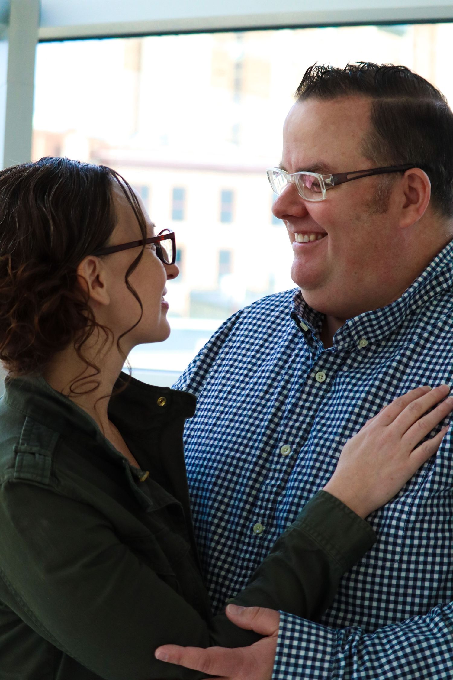 wife and husband holding one another