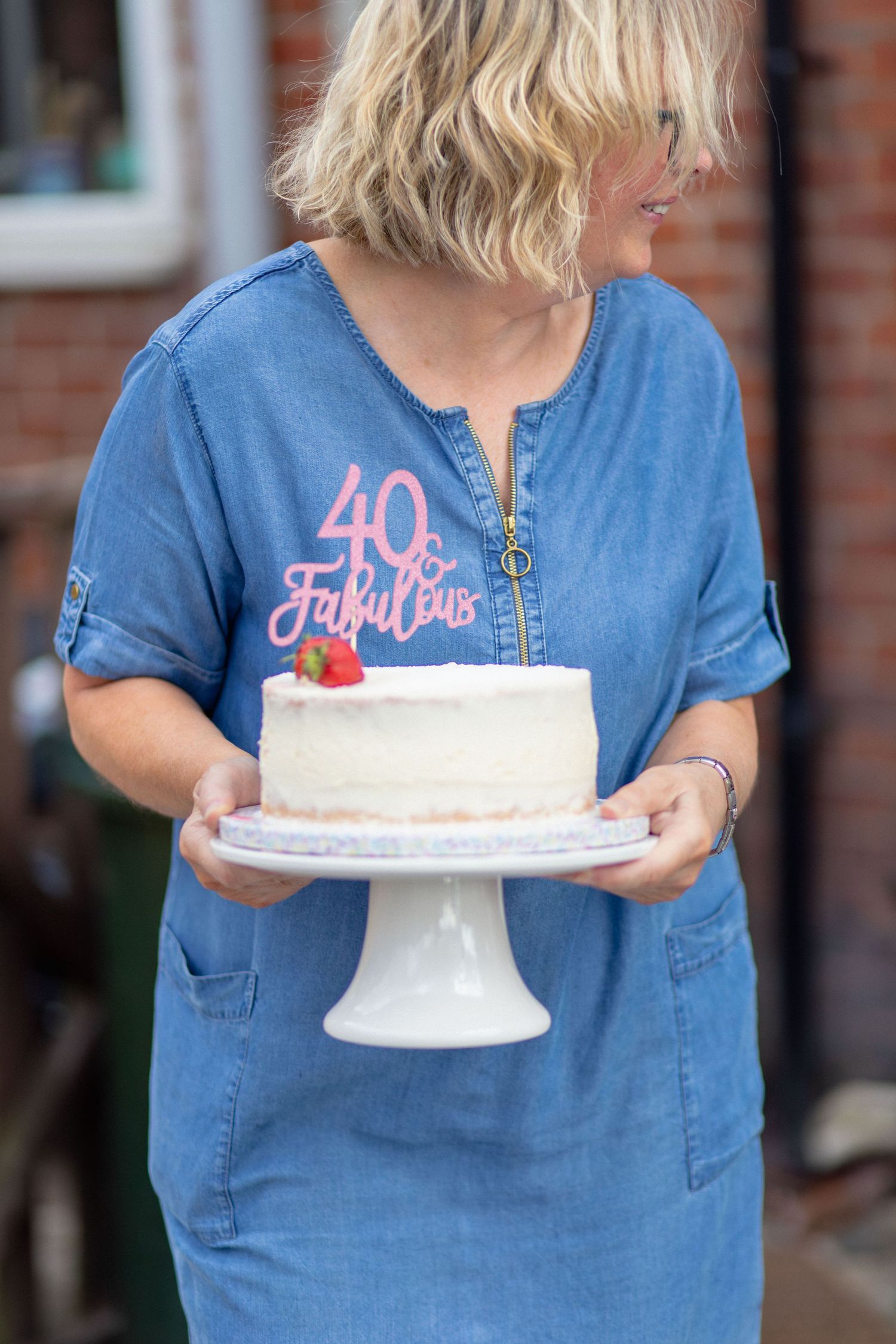 Guest holding a birthday cake during a 40th birthday celebration
