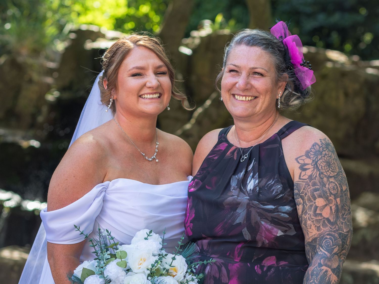 Bride smiling with  family member outside Clifton Park Museum.