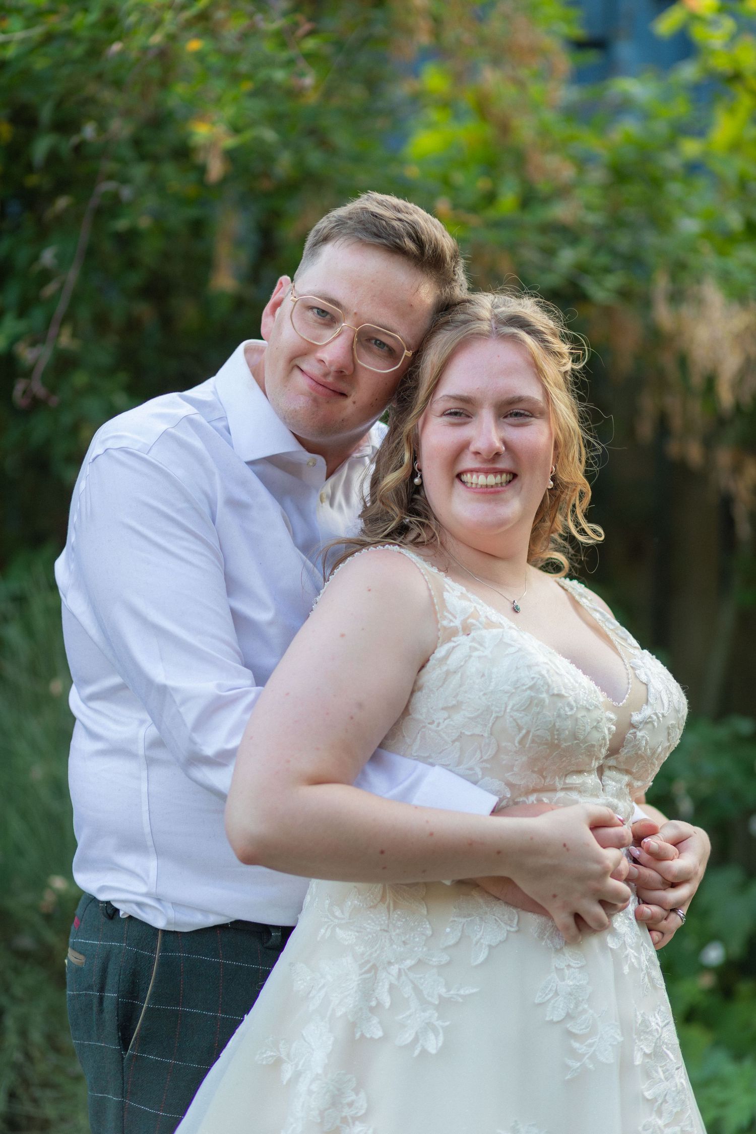 Bride and groom embracing outdoors at Elkington Church