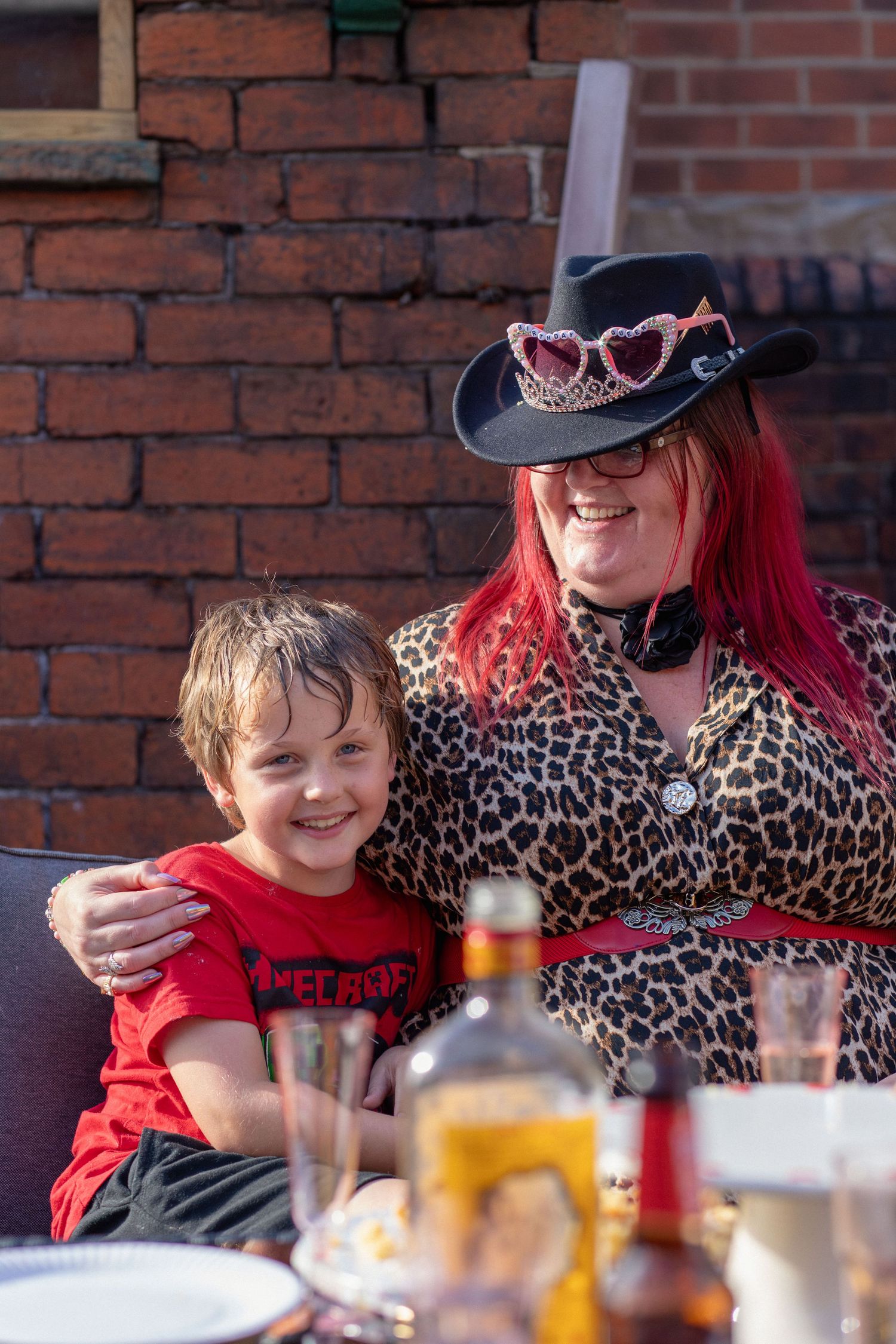 Child enjoying the celebrations with a guest at a 40th birthday party