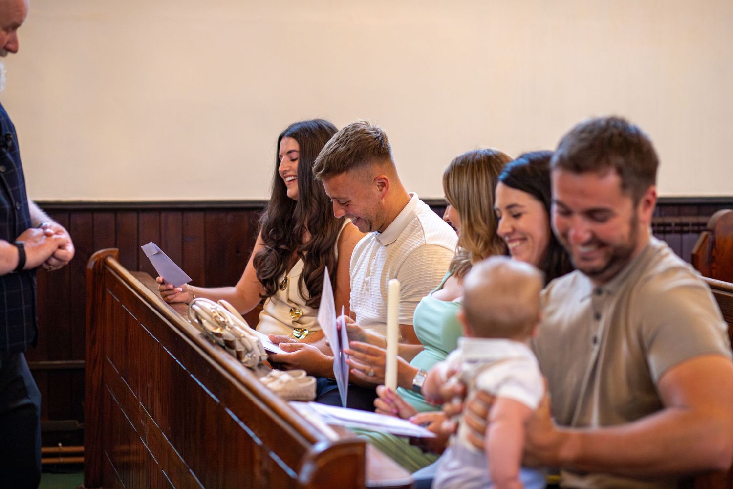 Friends and family laughing during a Christening Service in Church