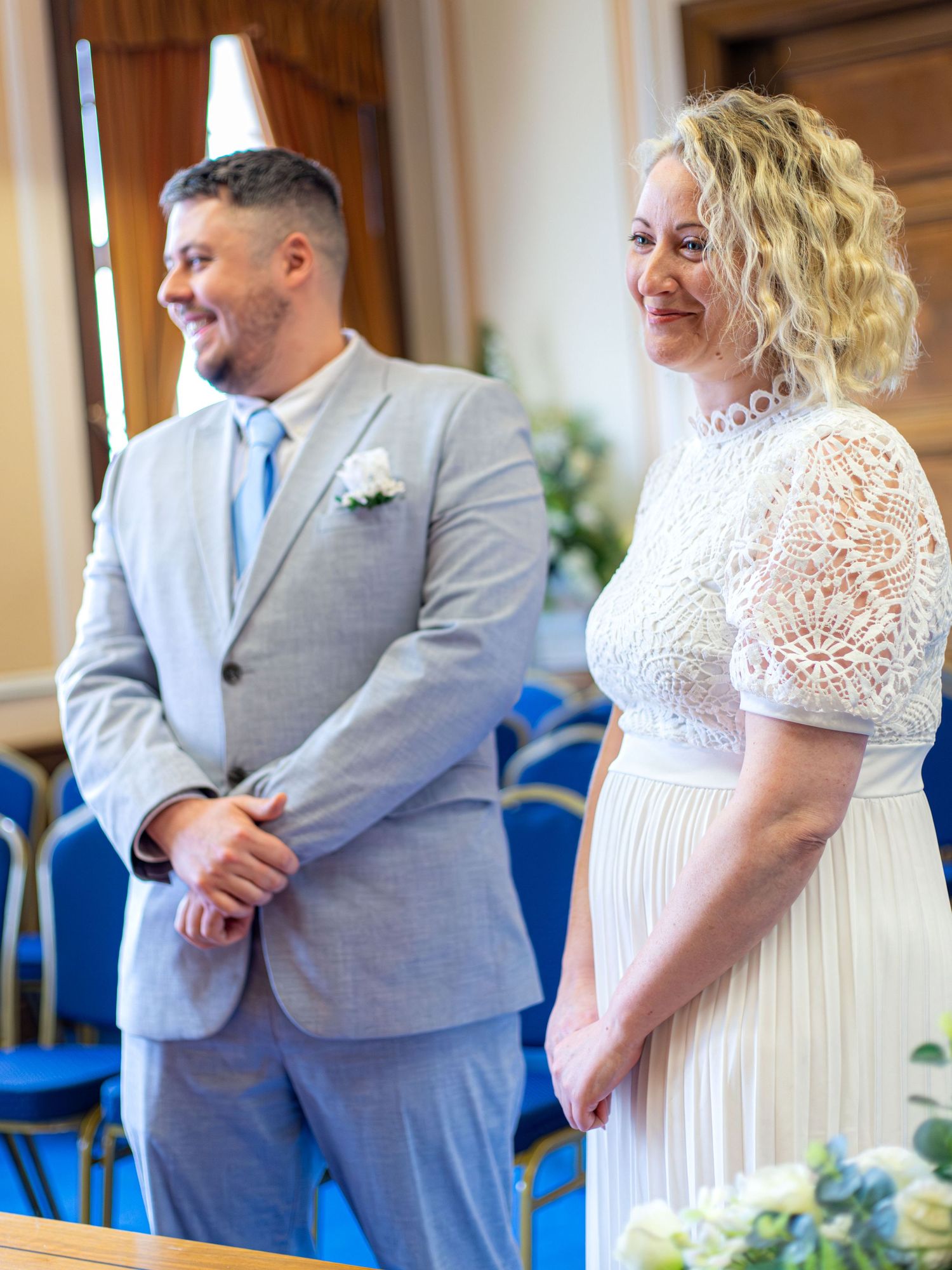 Bride and groom standing together inside Barnsley Town Hall during their wedding.