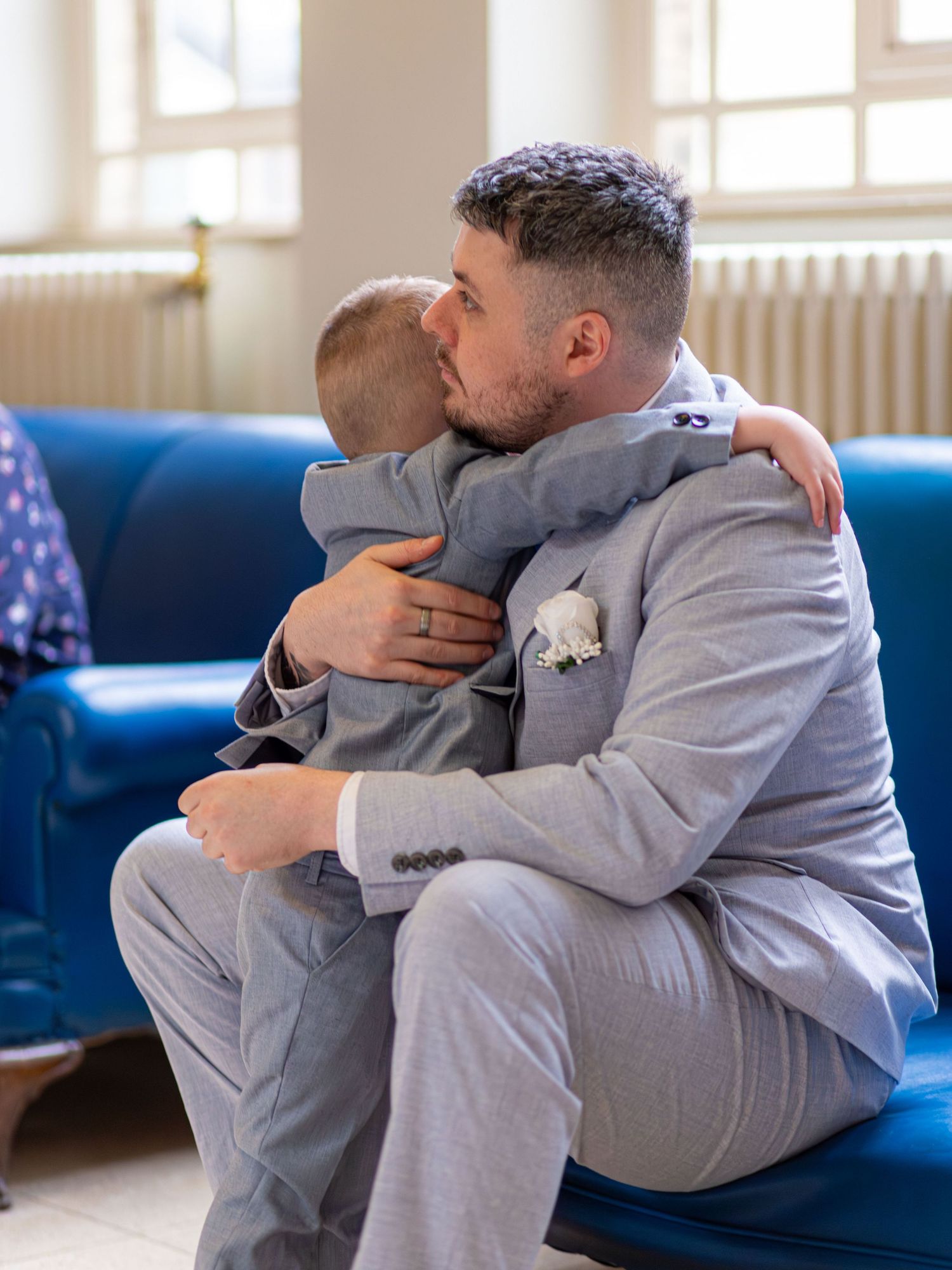 Groom sharing a moment with a young wedding guest at Barnsley Town Hall