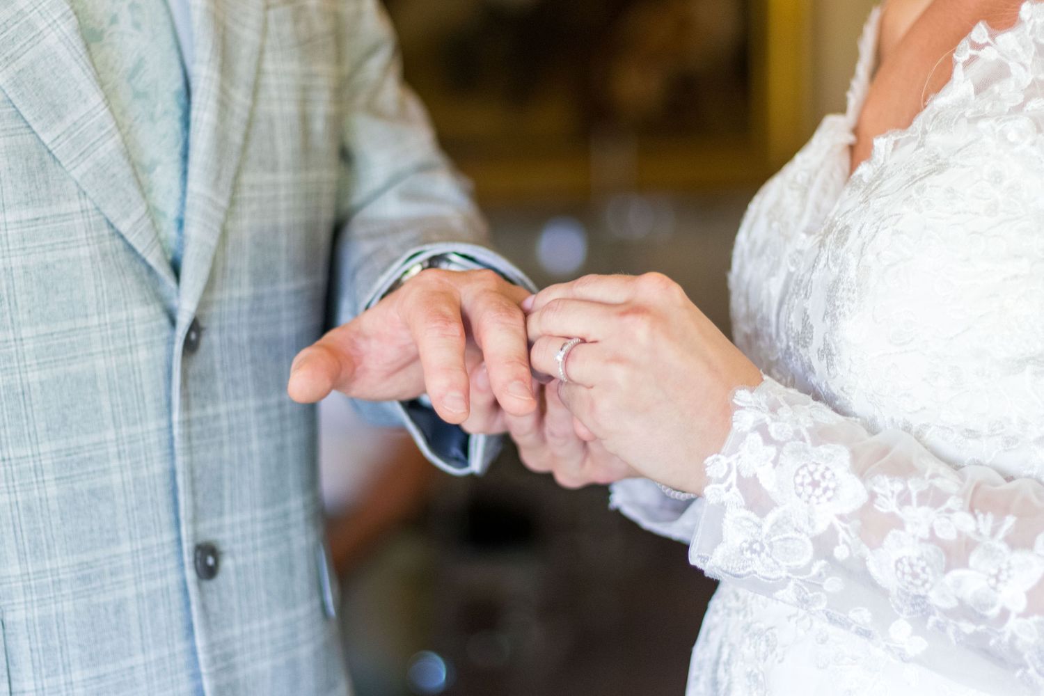 Bride and groom exchanging wedding rings at Clifton Park Museum