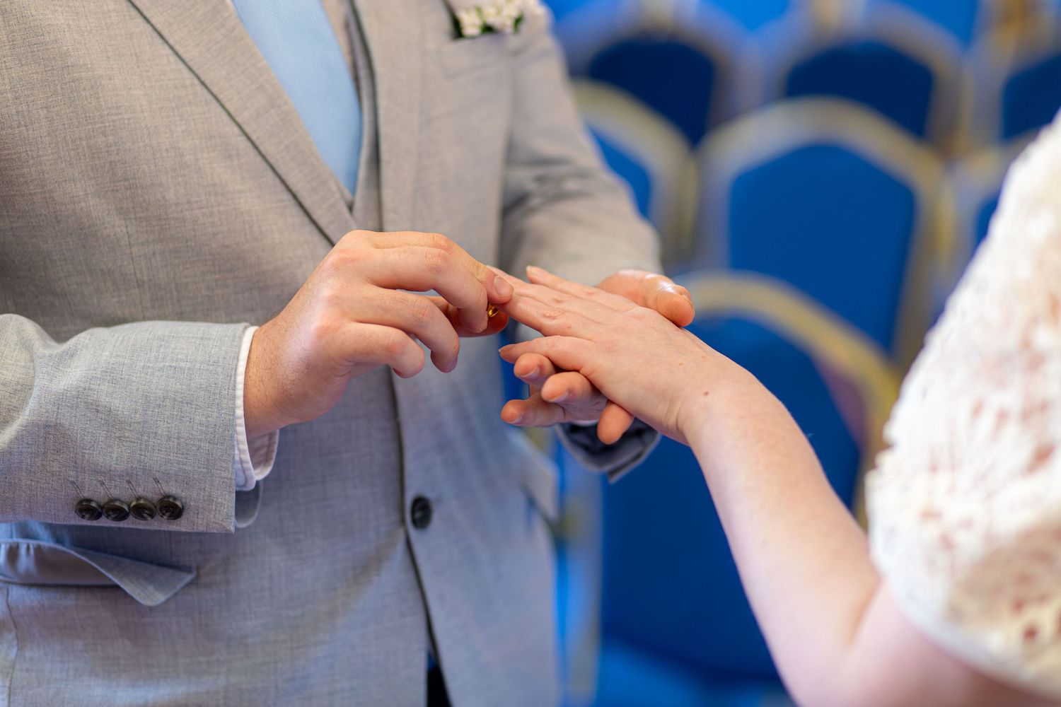 Bride and groom exchanging rings during their wedding ceremony at Barnsley Town Hall.