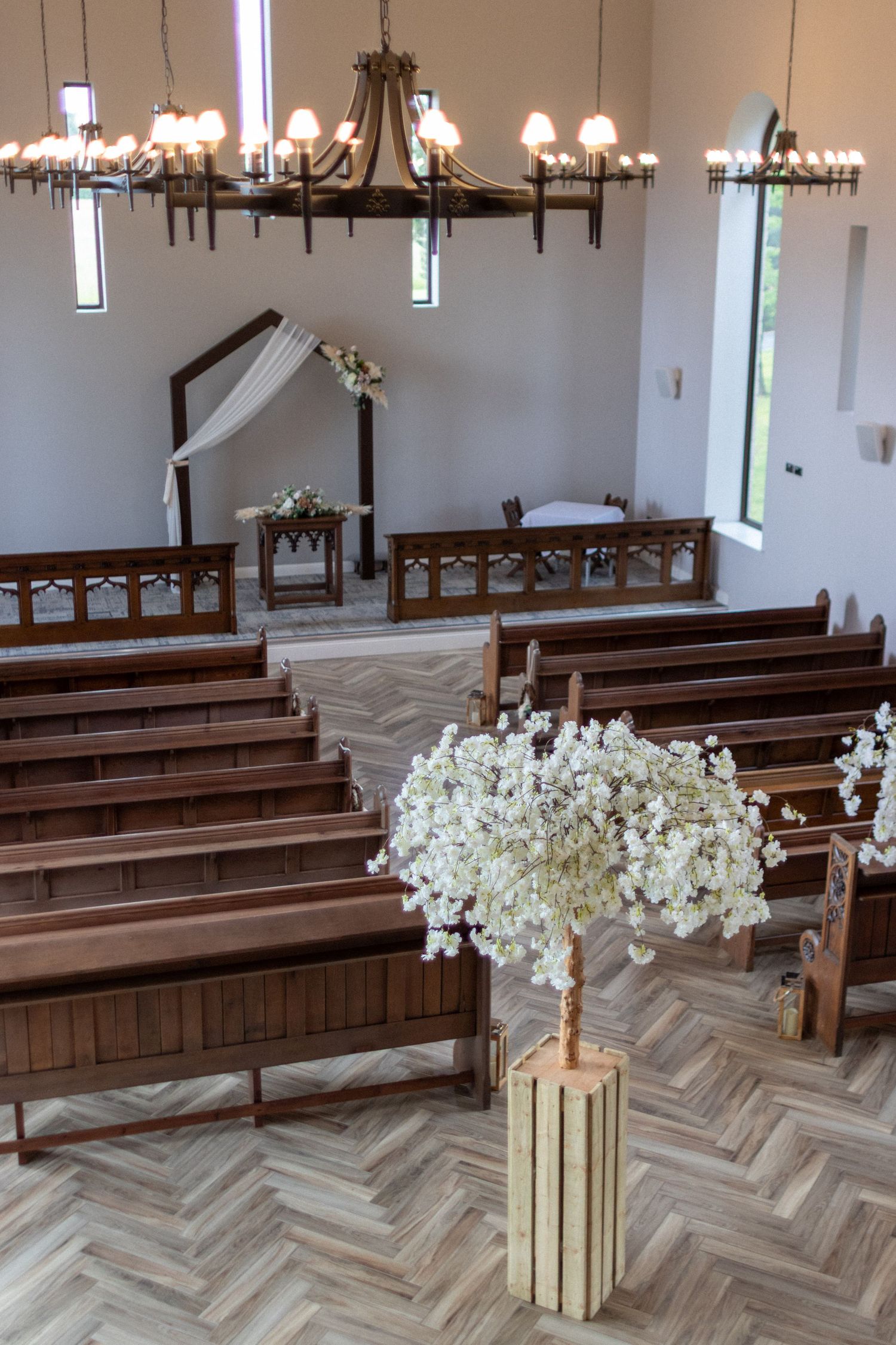Wedding venue with white flowers and pews