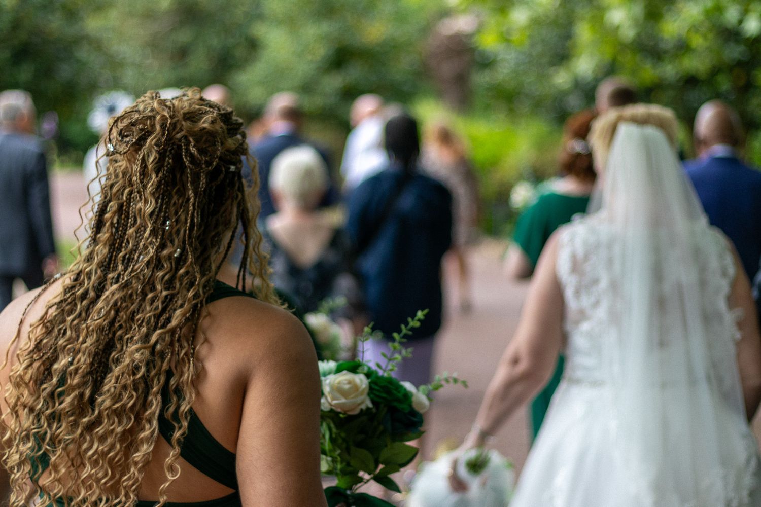 Wedding guests follow bride for portraits