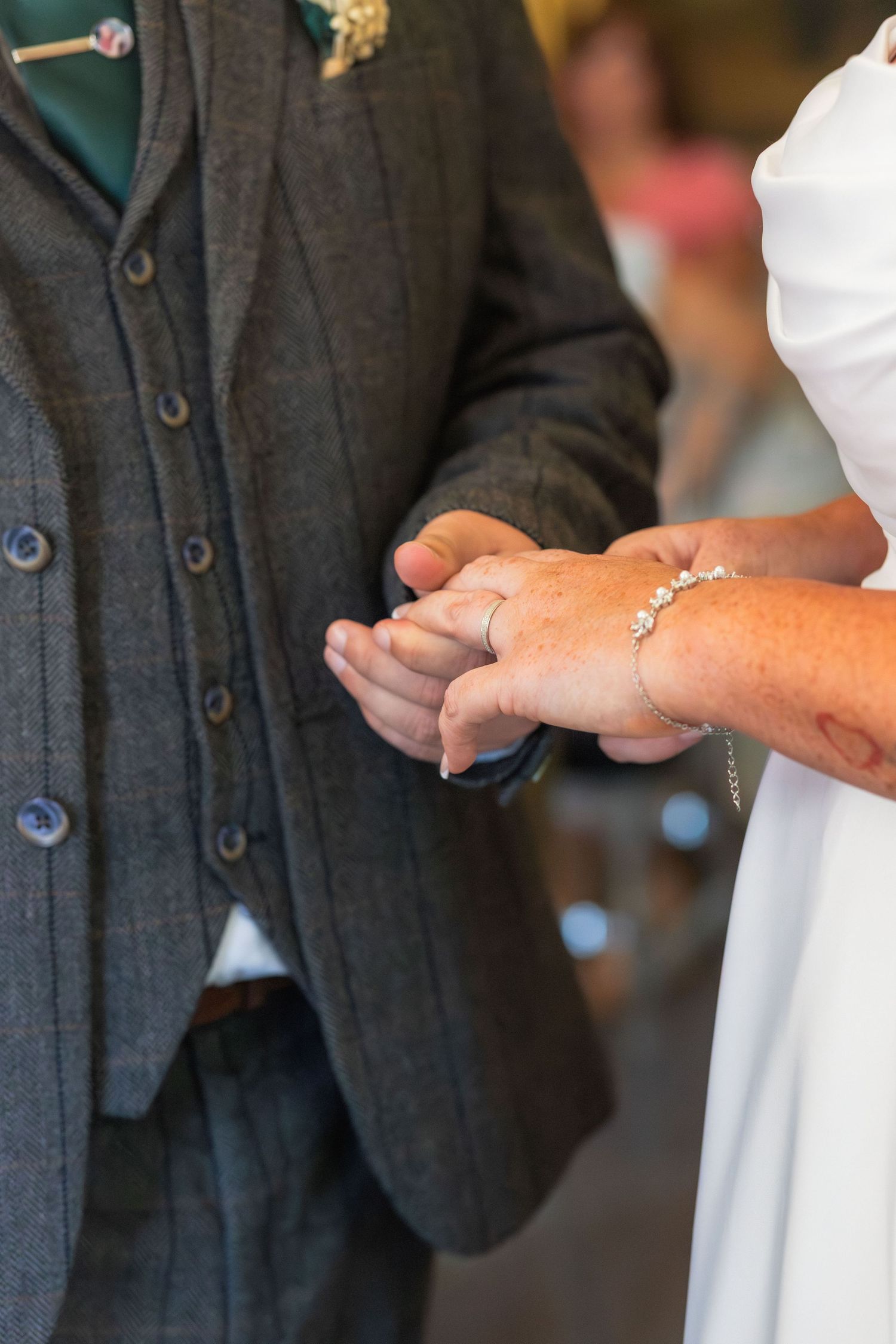 Wedding ring being placed on a hand during a ceremony at Clifton Park Museum