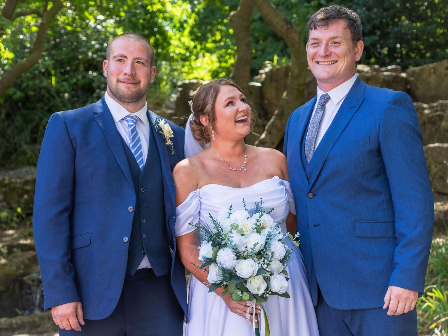 Bride with two wedding party members outside Clifton Park Museum