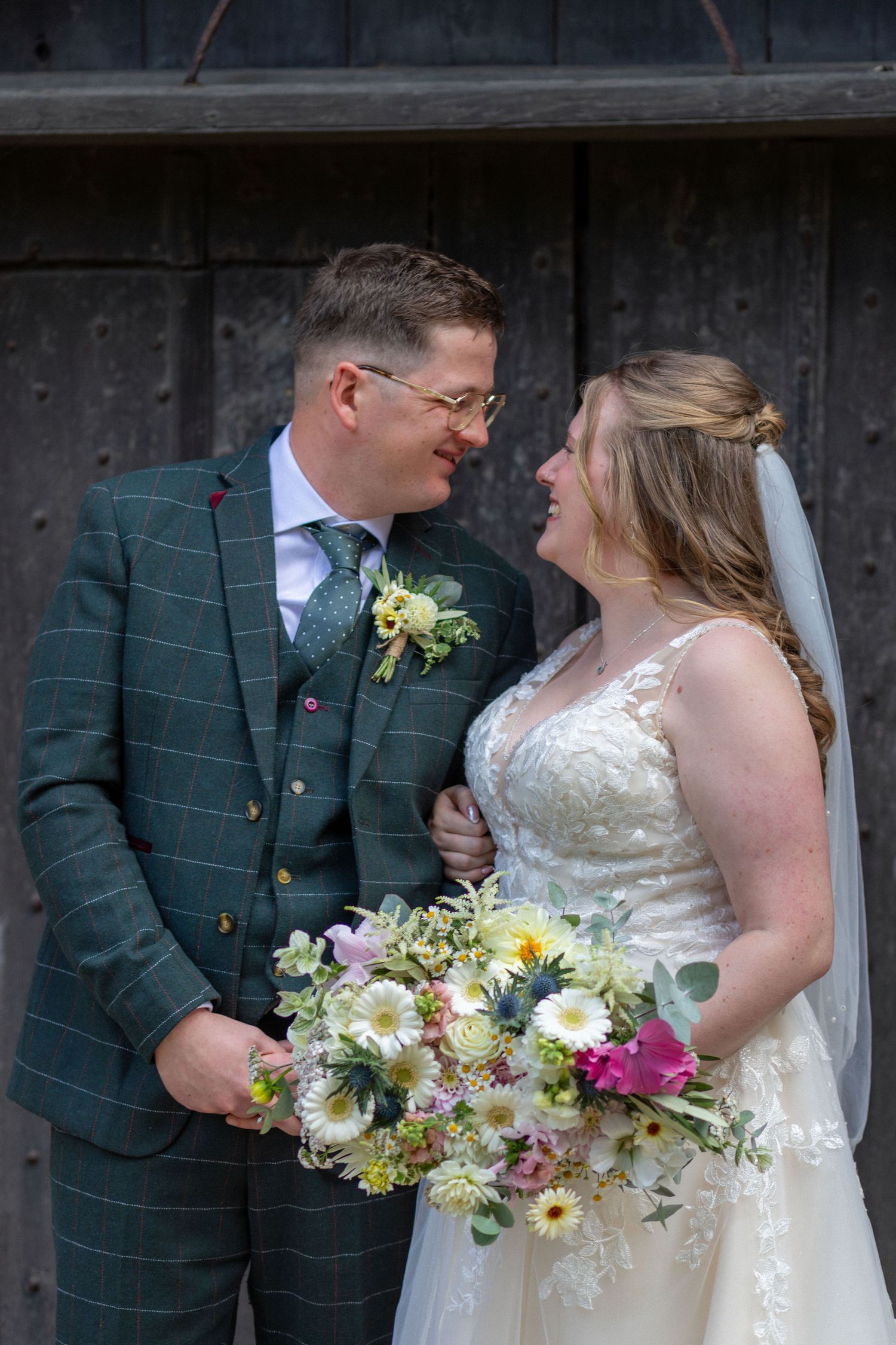 Bride and groom sharing a moment during their wedding at Eckington Church