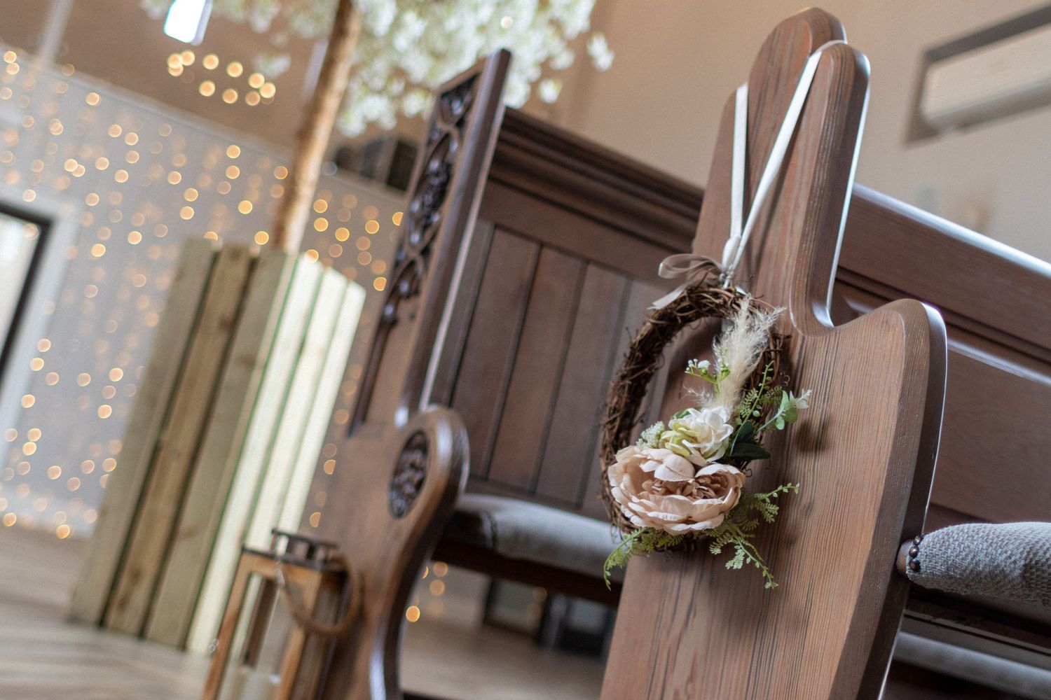 Decorated pews at a Burntwood Court wedding Venue