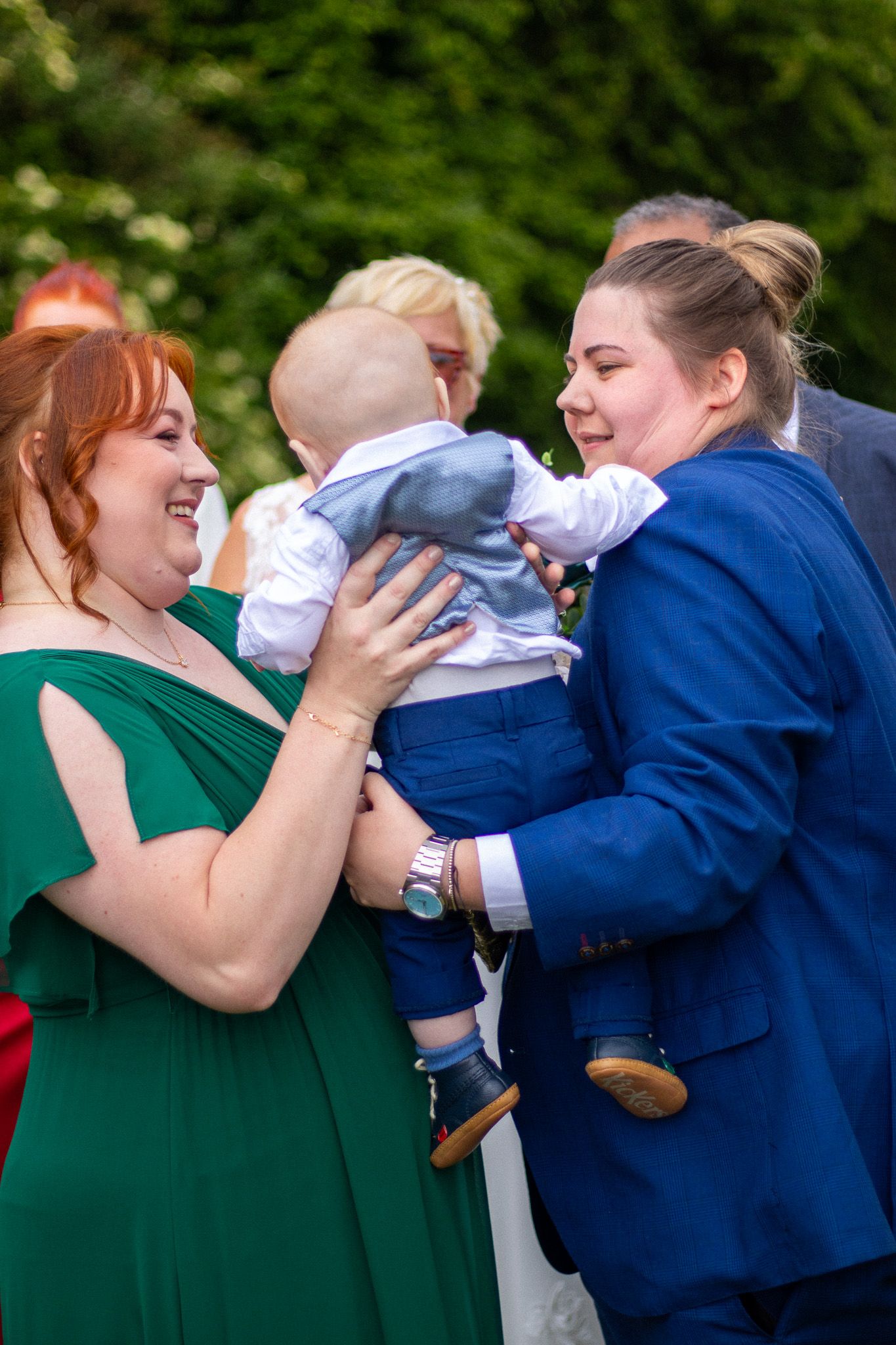 Family and Guests holding their children after a wedding