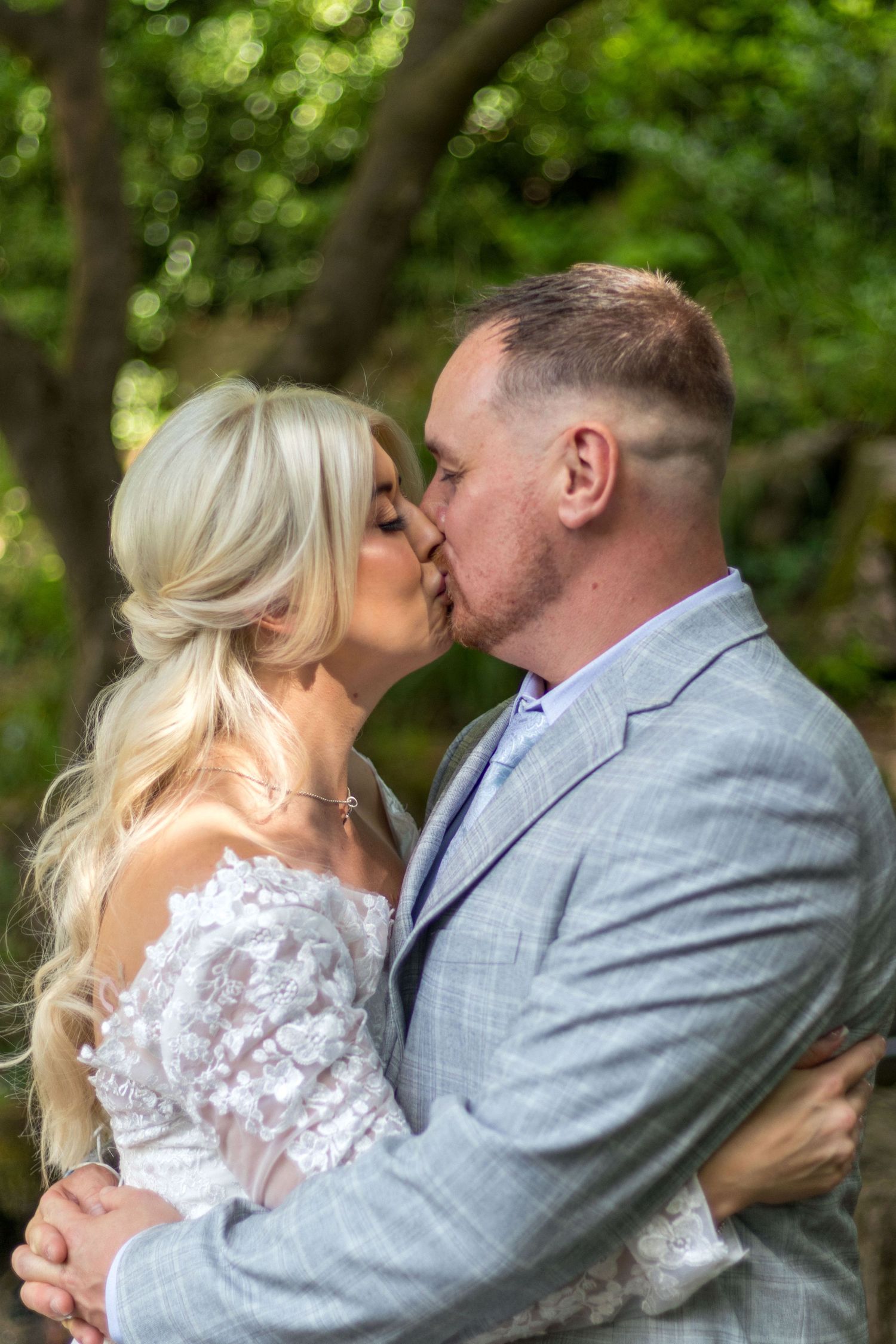 Bride and groom sharing a kiss outdoors at Clifton Park Museum