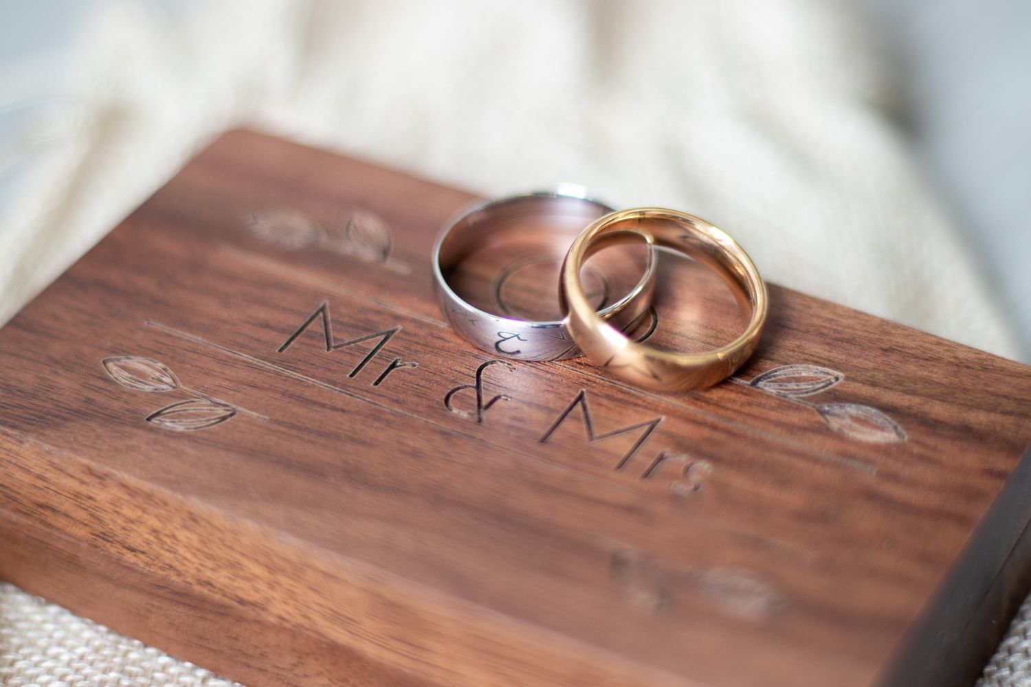 Bride and Grooms Wedding Rings on Mr and Mrs wooden box