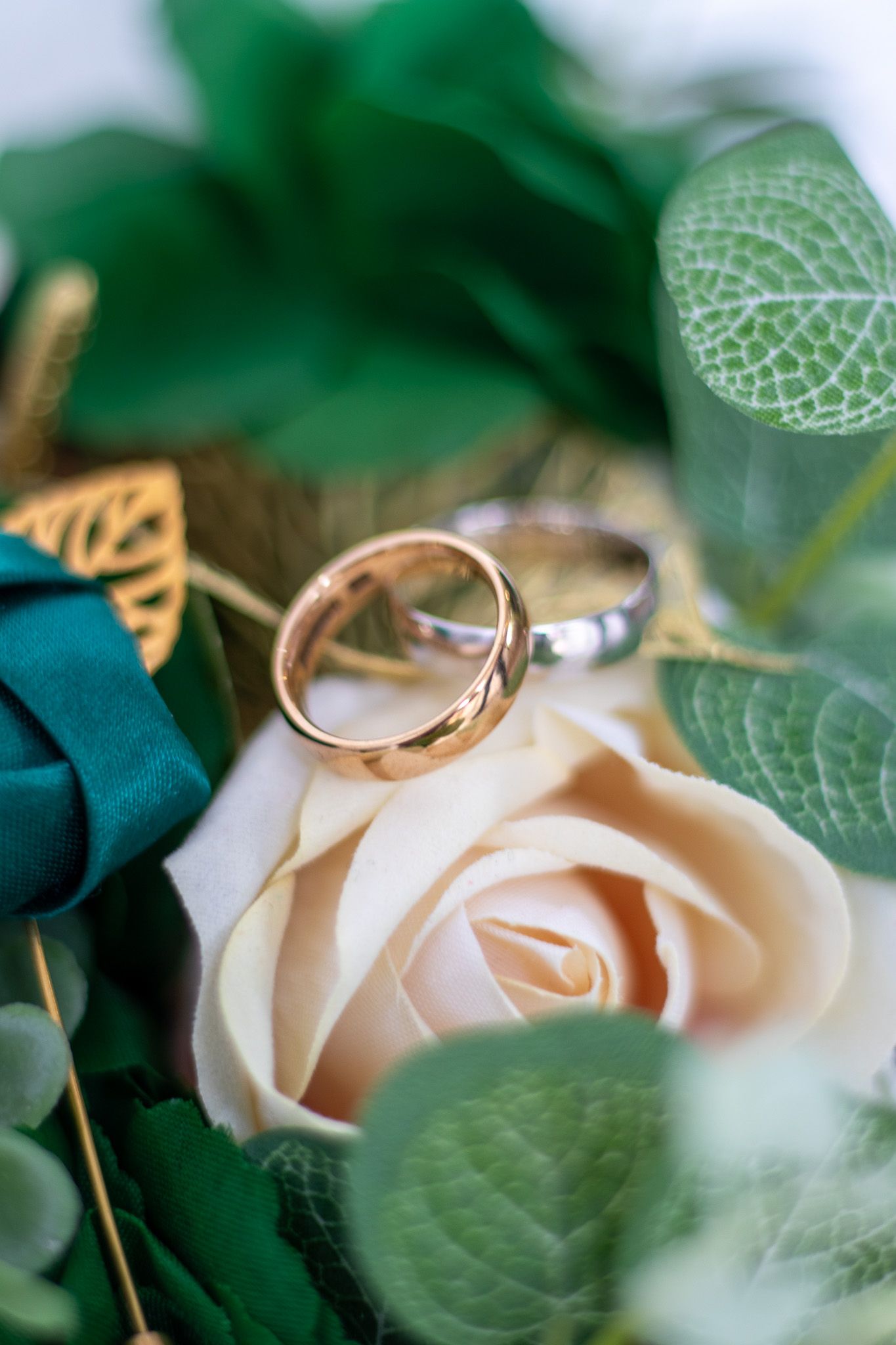 Gold and Silver Wedding Rings on a bouquet