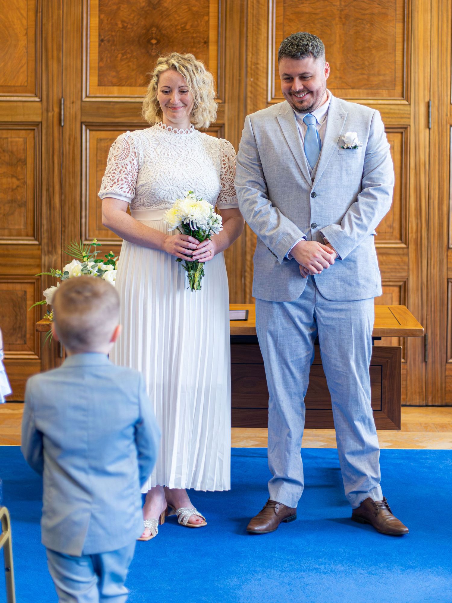 Bride and groom with a young wedding guest at Barnsley Town Hall