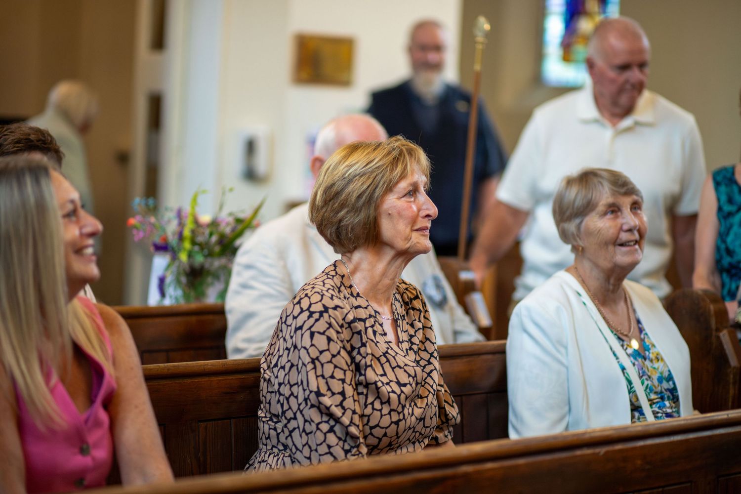 Family and guests watching the christening ceremony at St Thomas Church, Barnsley