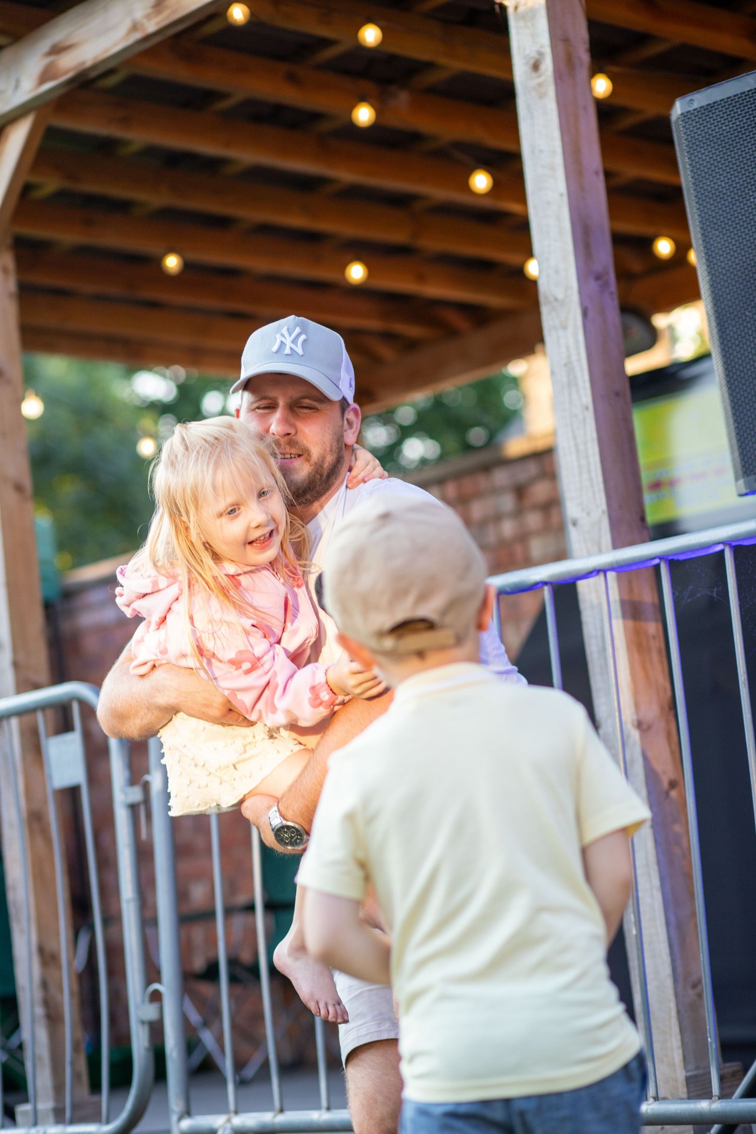 Candid photo of a Man holding his children, natural lighting