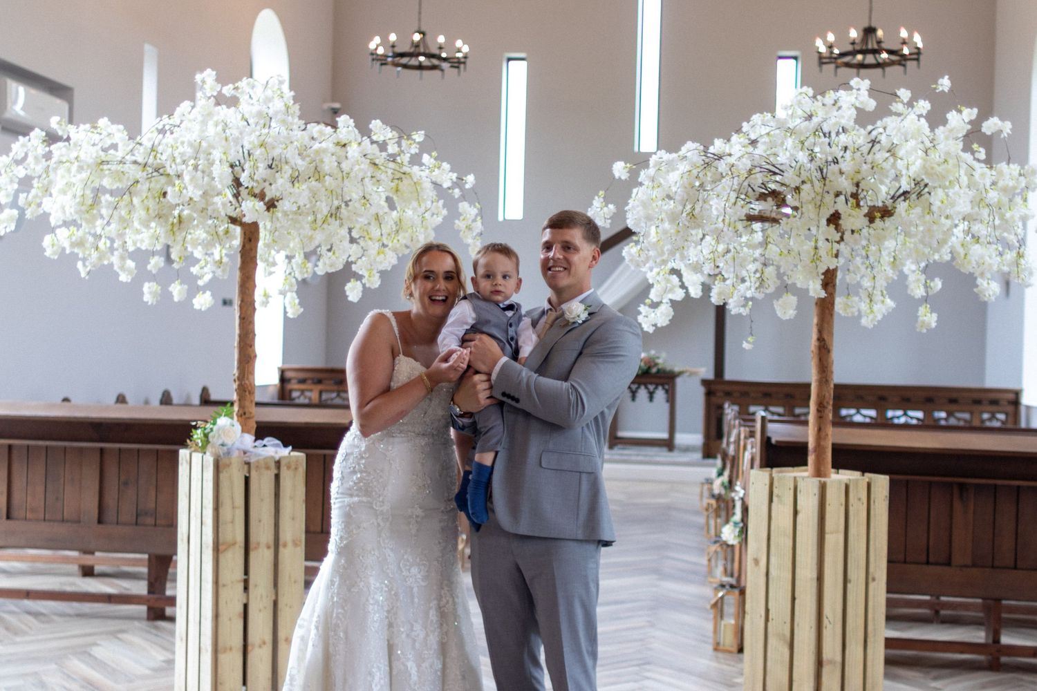 Bridge and Groom holding their son after their Wedding