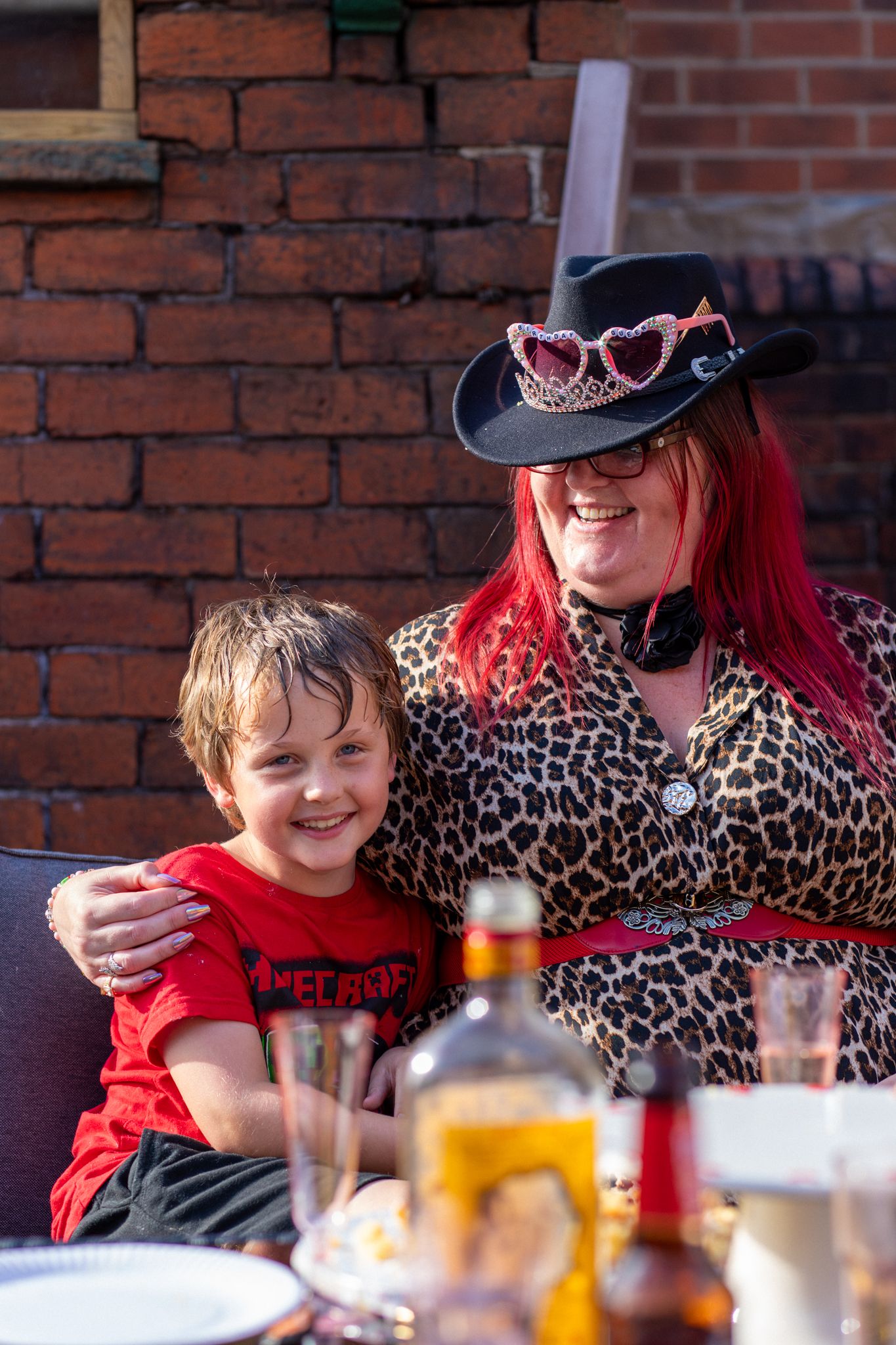 Mother and son smiling at an outdoor Birthday party