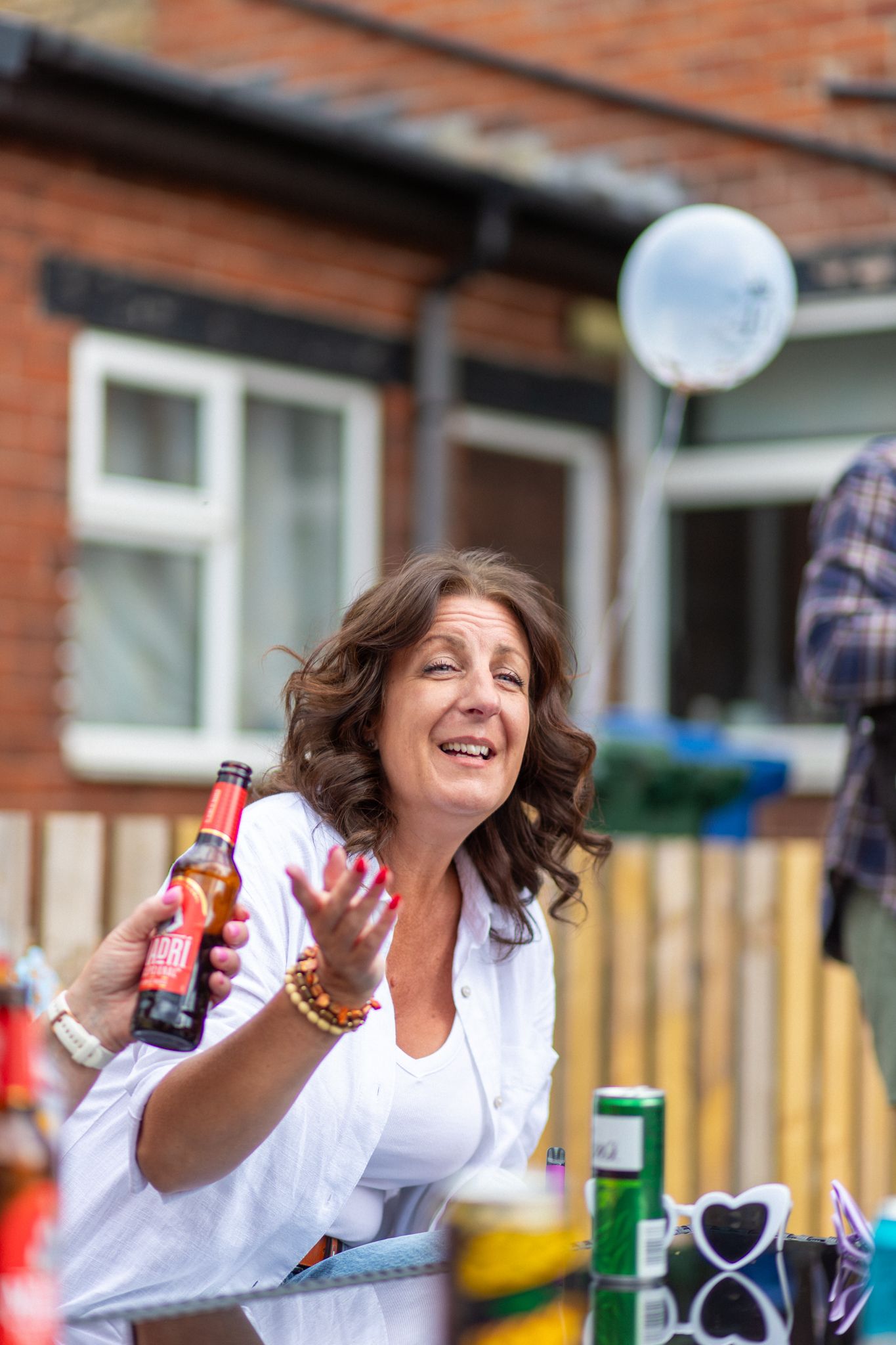 Woman outdoors at a garden party smiling
