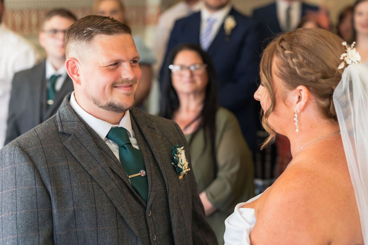 Bride and groom smiling at each other during their Clifton Park Museum wedding.