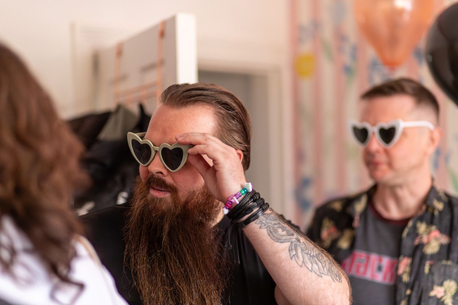 Men in silly glasses at an indoor Birthday party