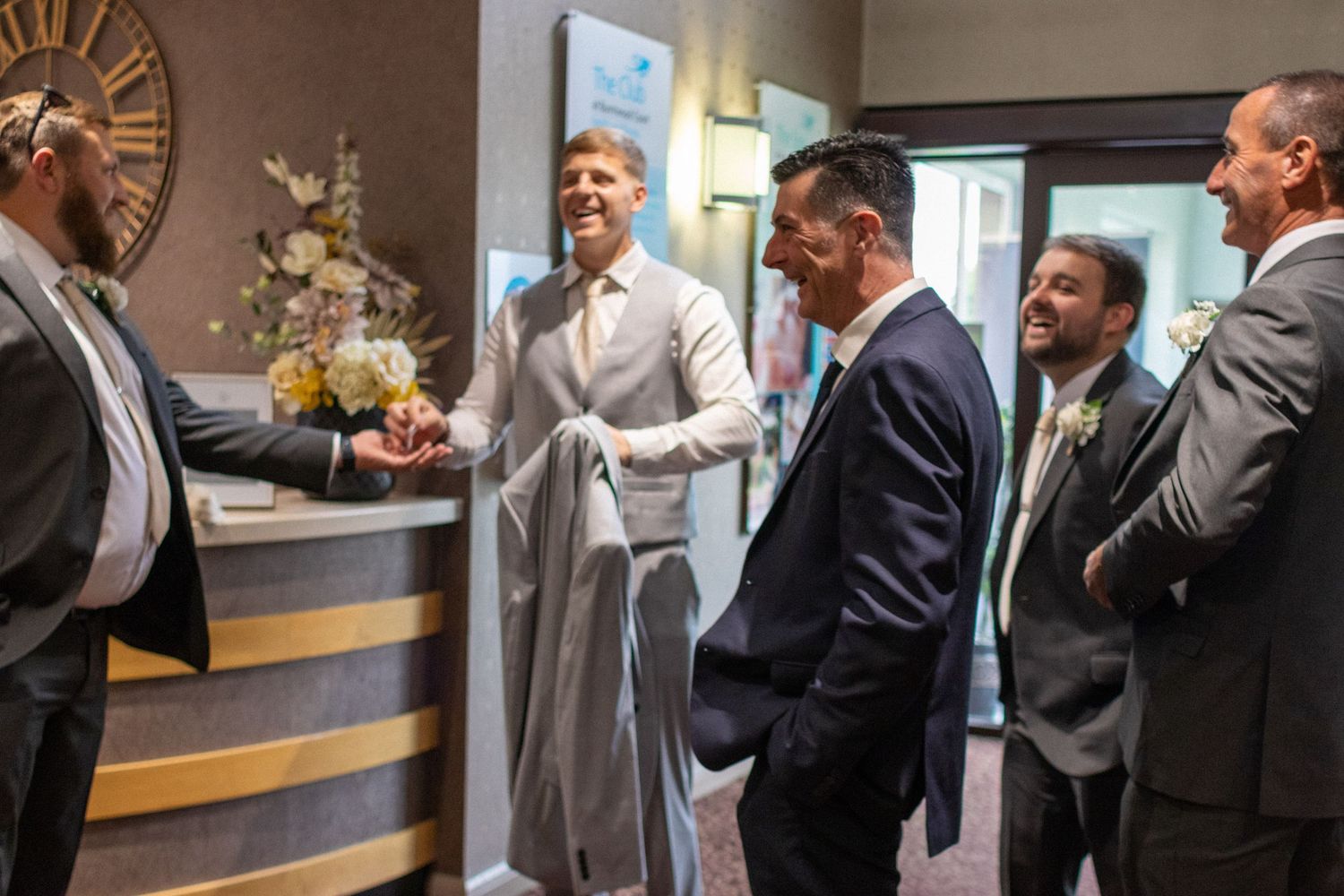 Candid photo of the Groom, family and friends arriving at a Wedding