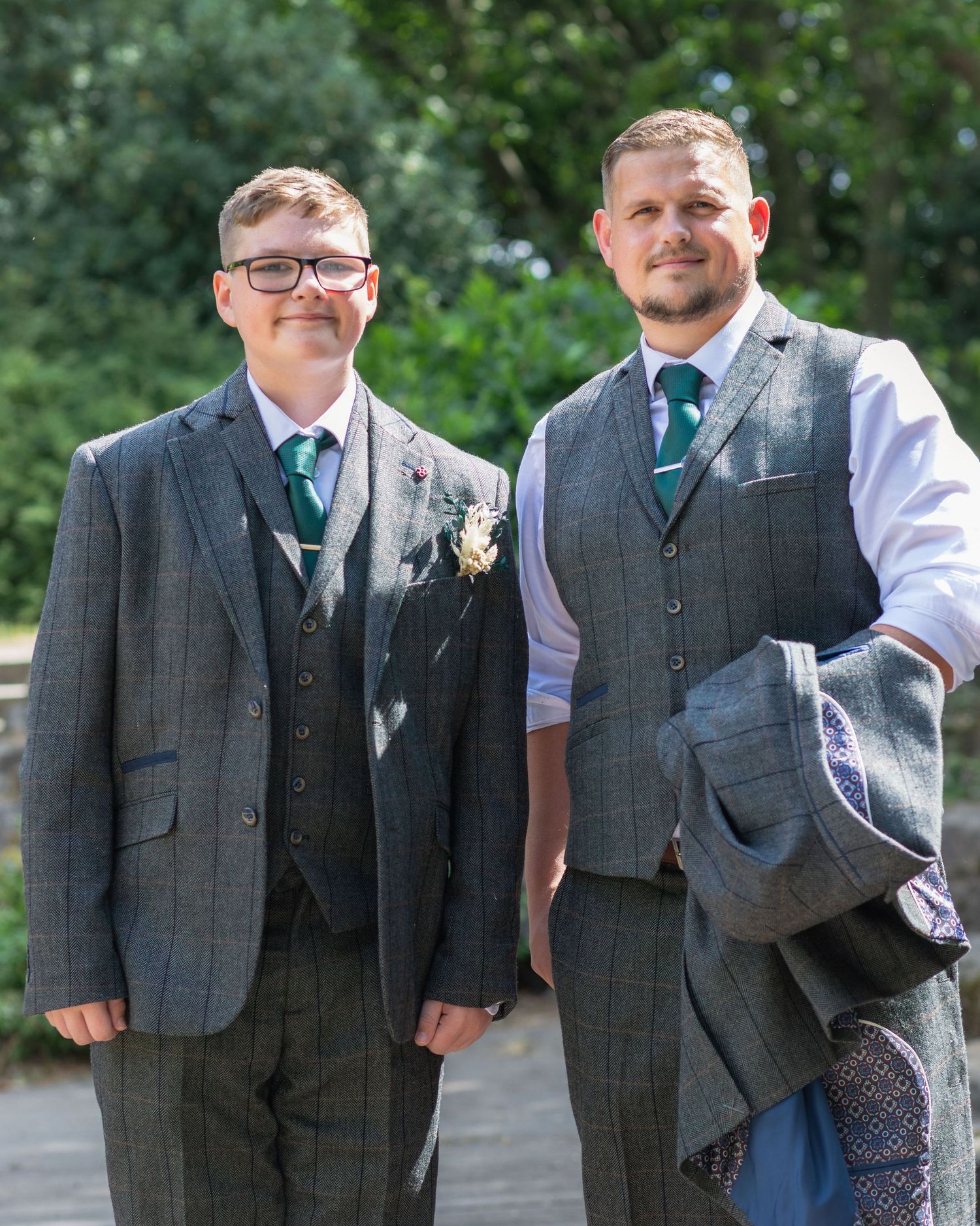 Groom and son standing together outside Clifton Park Museum at a wedding.