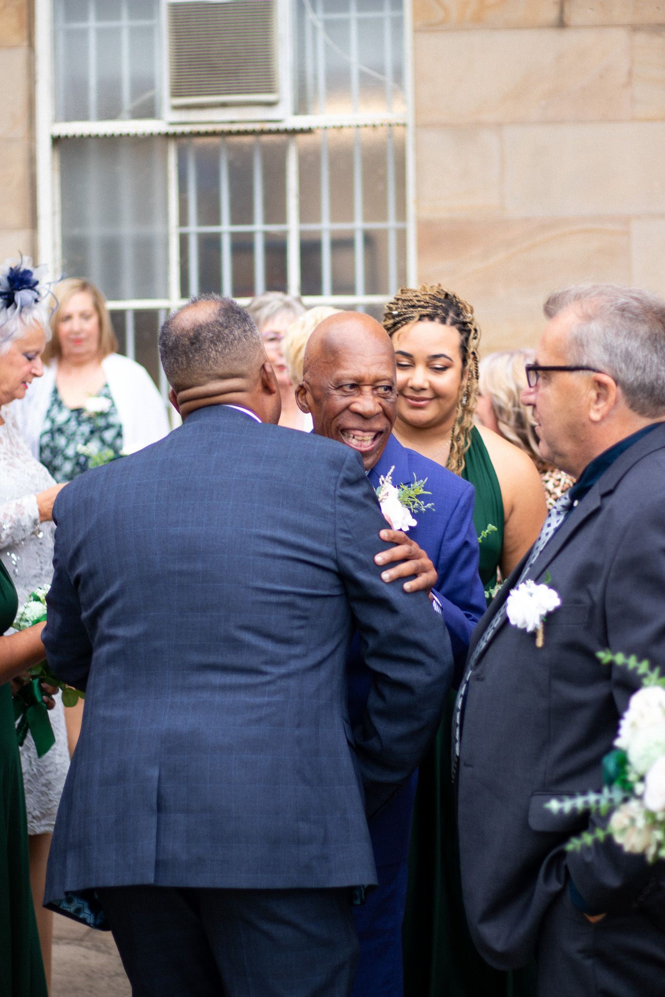 Family embrace after a Wedding outdoors