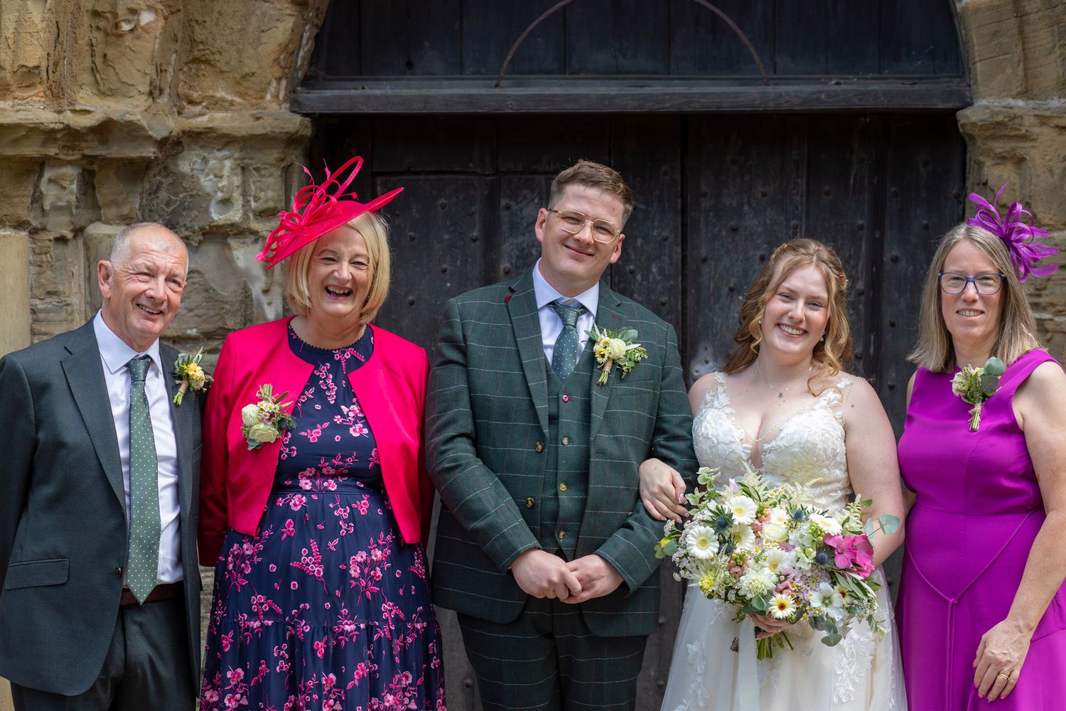 Candid family group photo of the Bride and Groom