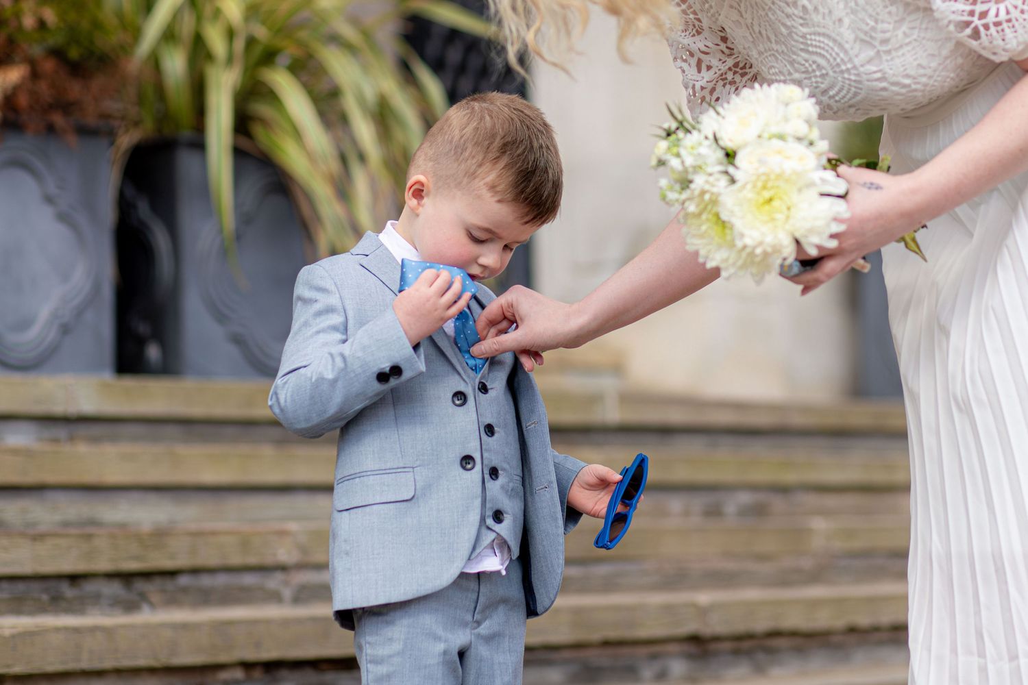 Young wedding guest reaching towards the bridal bouquet at Barnsley Town Hall