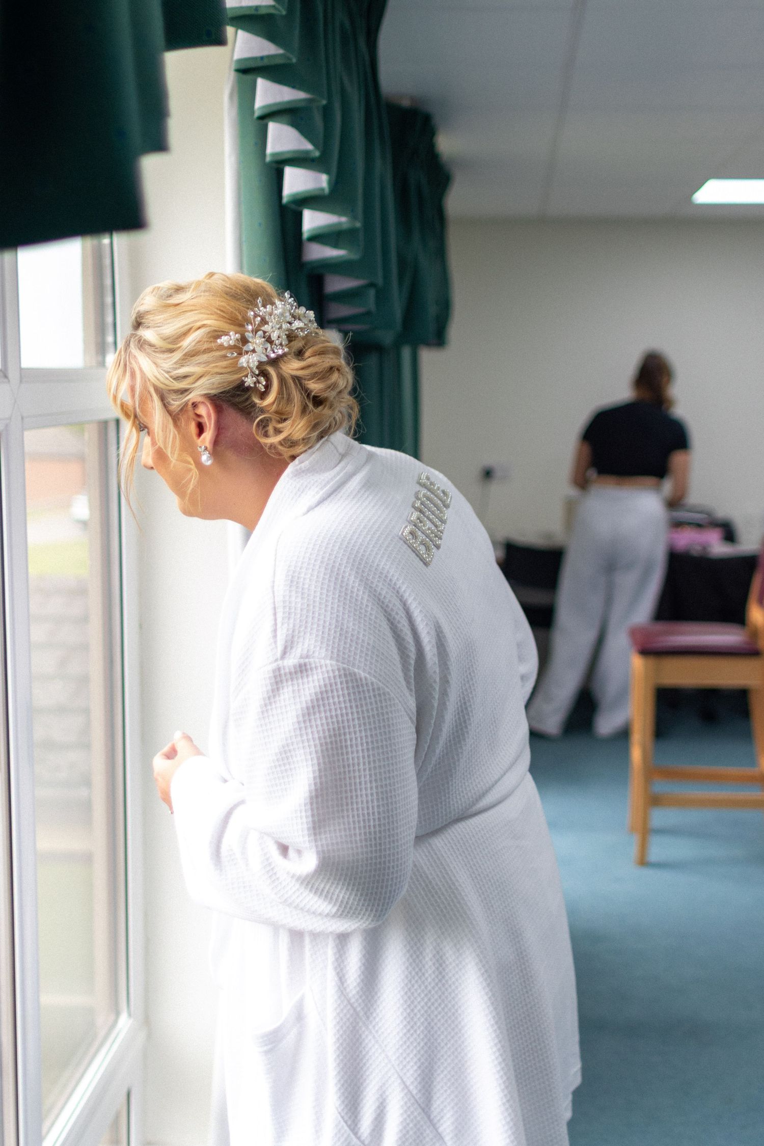 Candid photo of the Bride getting ready for her Wedding looking for the Groom
