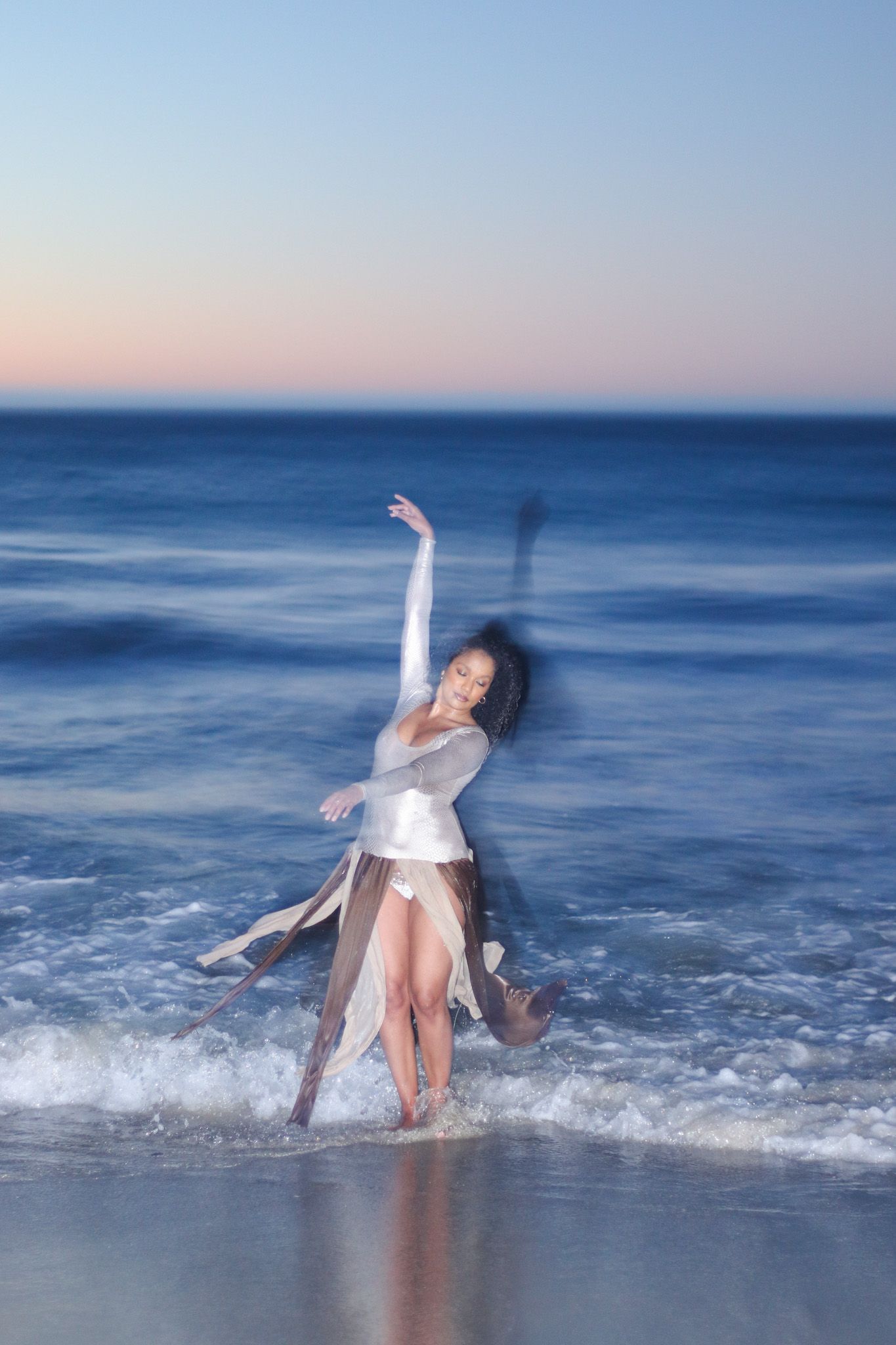 Young woman dancing on the beach